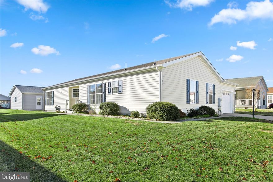 Introducing 21 Catts Lane, a welcoming home in the sought-after 55 plus community of Barclay Farms. This residence is being sold as-is and offers a comfortable blend of space, convenience, and community amenities that enhance everyday living. Thoughtful updates include a brand new roof in 2025, a new refrigerator in 2023, and a new kitchen floor installed in 2023. When originally constructed, an additional two feet were added to the home, creating a larger footprint than many neighboring properties.

Inside, an open floor plan and vaulted ceilings create a bright and airy interior that feels instantly inviting. The living room features a cozy gas fireplace, perfect for relaxing on cooler days. The primary bedroom includes an ensuite bath, while two additional bedrooms offer flexibility for guests or hobbies. A separate laundry room provides direct access to the garage for added convenience.

The new owner will assume the current lease, which began on June 1, 2017 and expires on May 31, 2026. Barclay Farms offers a vibrant lifestyle with amenities that include a pool, clubhouse, fitness center, spa, library, game rooms, walking paths, a catch and release fishing pond, fitness classes, clubs, and a variety of activities. The land lease includes access to all community amenities along with lawn maintenance, trash removal, and road maintenance.

Conveniently located in Camden Delaware, this home is just a short drive to shopping, restaurants, healthcare, the Delaware beaches, and more. A wonderful opportunity to enjoy comfortable living in a friendly and amenity rich community.