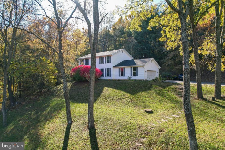 If you are looking for a home where nature abounds and privacy is a must.....look no further than 8911 Dogwood Road, Charming 4 bedroom, 2.5 bath home with new HVAC system, recently replaced shingles and beautiful hardwood floors. Stay cozy this winter with the warmth from the woodstove and be impressed with the extra space you'll find in the basement with brand new luxury vinyl plank and a walkout door... All of this on just under 5 beautiful acres. Located near historic Ellicott City, Woodstock and Granite. Lots of trails for hiking and biking enthusiasts. Country living, minutes from town.  Schedule your tour today....