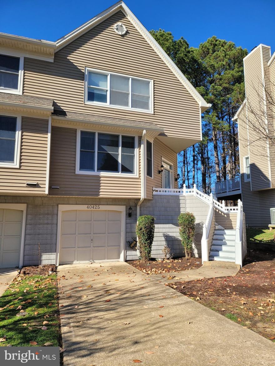 Awesome water view end unit in Breton Bay with tranquil water views!  Close to shopping, the PAX River base, and Breton Bay golf course is close by as well.   This end unit has Two Primary sized bedrooms with cathedral ceilings with new carpet and private in suite bathrooms.  There is exceptional amounts of closet and storage space in the unit.  Lower level can be used as a bedroom as well which also has a full bathroom.   Large open living room and dining areas with a wood burning fireplace and a deck to enjoy the view.  Large kitchen with island has eat in area as well.  The back deck off the living room is decked out with string lights and a view!  Lower Level is fully finished and has a large recreation room area and another full bathroom for convenience.  Outside the lower level recreation room is nice size patio for sitting and enjoying the view.  Close to base and shopping and restaurants.  Entry to the 1 car garage is on this level as well.