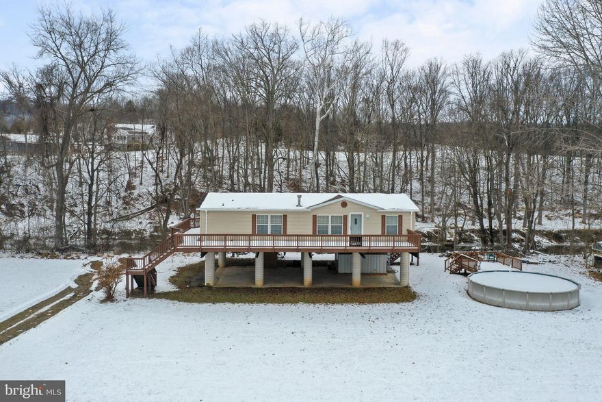 Nestled along the picturesque 1057 Hummingbird Ln in Capon Bridge West Virginia, this riverfront property epitomizes the essence of tranquil living. Step inside, and you'll be greeted by the allure of newly installed luxury vinyl plank flooring, seamlessly complementing the open concept design of the home. The three spacious bedrooms and two full bathrooms provide a comfortable retreat, with the primary bedroom standing out for its generous space, private sitting room, and  luxurious en-suite bath featuring a large soaking tub and tasteful tile flooring—a sanctuary for relaxation. Beyond the interior, the property unfolds its charm with two expansive decks that offer sweeping views of the Cacapon River and the surrounding mountains. Head down the stairs to the water's edge, and you'll find yourself immersed in the serenity of riverside living. This gorgeous riverfront oasis presents an opportunity to escape into nature's beauty—don't miss the chance to make it your own and embrace the tranquility of this stunning retreat.
This fully furnished home could be a full time, part time or short term rental.