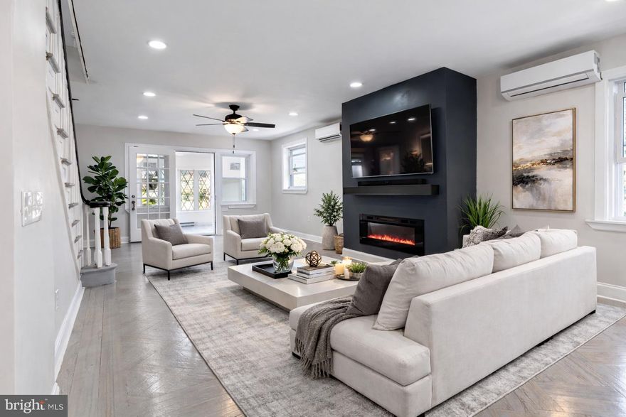 Welcome to 2414 77th Avenue — a beautifully updated end-unit row home nestled in the heart of West Oak Lane. Step into the enclosed front porch, a versatile space perfect for a cozy sitting area, reading nook, or functional mudroom. From there, you’re welcomed into a spacious open floor plan designed for both everyday living and effortless entertaining. The expansive living room with stained original hardwood flooring, recessed lighting throughout, and a striking accent wall featuring a built-in electric fireplace — the perfect focal point. The formal dining room offers ample space for hosting gatherings and holiday dinners. The large eat-in kitchen, complete with a peninsula and overhang for additional seating, has quartz countertops, white shaker-style cabinetry, a tiled backsplash, pot filler, and a full stainless steel appliance package including a side-by-side refrigerator, dishwasher, microwave, and five-burner gas range. Step directly from the kitchen onto the oversized rear deck — ideal for summer grilling, relaxing evenings, and entertaining guests. Upstairs, you’ll find three spacious bedrooms, all featuring original hardwood flooring and generous closet space. The owner’s suite is filled with natural light and offers dual closets along with a private en-suite bath showcasing a tiled shower with modern fixtures and newer vanity. The fully tiled main hall bathroom includes a tub with built-in niche and a newer vanity for a clean, updated feel. The fully finished basement expands your living space with a built-in bar, powder room, laundry area, and convenient side entrance — perfect for entertaining, a recreation area, or additional flexible living space. You’ll also appreciate inside access to the one-car garage, plus a private driveway for additional parking. Enjoy morning coffee or evening relaxation on the inviting front patio. Conveniently located near shopping centers, local restaurants, schools, and parks, with easy access to Route 309, the PA Turnpike, and Broad Street. Schedule your private showing today and make 2414 77th Avenue your next home.