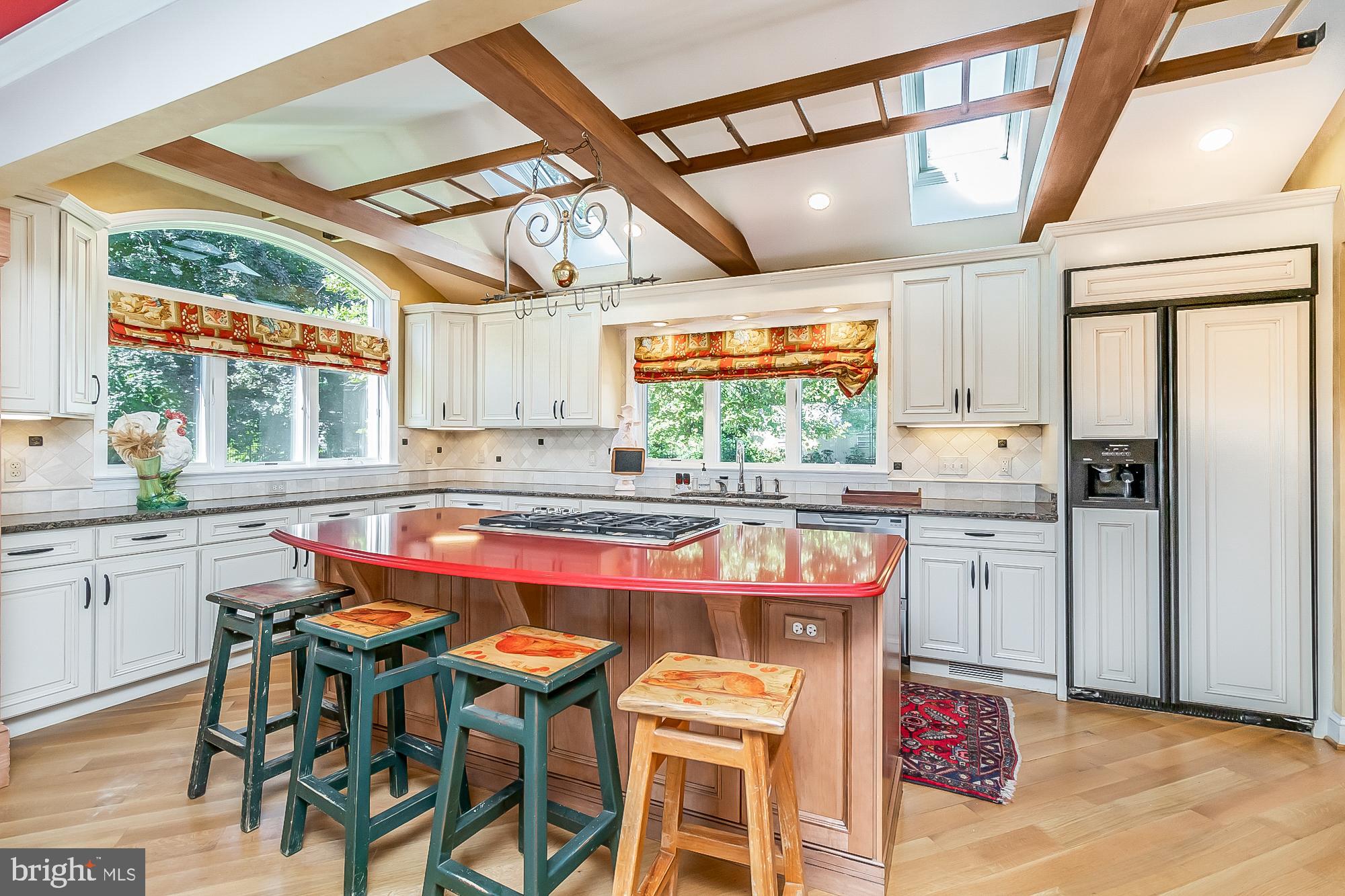 OPEN HOUSE! Sunday, April 16th from 11 am to 1 pm! Gorgeous home located on a private 1.5 acre lot in Glen Arm! Entry level features a gourmet kitchen with Wellbourn custom cabinets, Zodiaq counters on island, granite counters, Wolf gas range with rise top down draft, two Thermador ovens with warming drawer, Kitchen Aid side by side refrigerator/freezer, double dishwasher, and under counter microwave. Family room is open to the kitchen and features a custom wet bar with onyx back splash and Zodiaq counter, hardwood floors, gas fireplace with custom mantle and built-ins. Large living room with hardwood floors, built-in book shelves and Hartman pellet stove insert . Formal dining room with crown molding, chair rail and wainscoting. Three season sun room with baseboard heating, wall of windows and access to paver patio. Upper level includes four bedrooms with one bedroom currently being used as a laundry room. Primary bedroom with newly refinished hardwood floors, two closets and custom designed en suite bath with heated floors, antique custom conversion dress sink and soaking tub. Laundry room with built-ins and Corian tops. Finished basement with bar, built-ins, half bath and cedar closet. Oversized two car garage with quarter saw oak cabinets and attic storage above. Great back yard with six foot high steel fencing and two sheds (one with electric). Generac propane generator. Full house solar with 39 panels which generates income and electric. Wonderful location in Glen Arm on a no thru street!