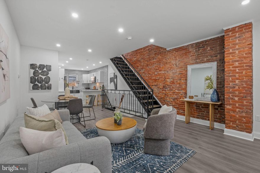 Newly transformed with a down-to-the-studs renovation and luxury finishes throughout, 1922 S 21st St is a standout rehab in sought-after West Passyunk! This move-in ready home offers 2 bedrooms, 3.5 bathrooms, a huge finished basement, and a large private patio. Out front, the freshly painted facade and welcoming porch create the perfect first impression on a quiet, low-traffic block. Inside, the bright and airy main level is framed by soaring ceilings, luxury plank flooring, and recessed lighting. An exposed brick feature wall and distinctive wrought iron railings add warmth and character throughout the open layout, where there’s plenty of space to relax, host friends, and entertain with ease. At the heart of the home is a stunning chef’s kitchen fitted with white shaker cabinetry, quartz countertops with breakfast bar seating, stainless steel appliances, a farmhouse sink, and a dramatic ceiling-height tile backsplash that elevates the entire space. A sleek powder room with a bold custom tile accent wall sits just off the kitchen. Out back, the oversized private patio acts as a secluded outdoor escape, perfect for summer barbecues, dining under the stars, or lounging with friends and family. More living space is found downstairs in the expansive finished basement, offering flexibility for a media room, home gym, office, guest space, or playroom, along with a sleek full bathroom and extra storage. Upstairs, the sunlit primary bedroom suite boasts tall bay windows, exposed brick, a custom walk-in closet, and a luxurious ensuite bathroom featuring a double vanity, statement tilework, and a glass-enclosed shower. Down the hall is the laundry closet, another luxurious full bathroom with upscale finishes, and a second bright bedroom. In addition to everything inside, this fantastic West Passyunk location earns a Walk Score of 94! You’re steps from top restaurants, cozy cafes, local shops, and popular parks. Shopping centers with stores like ACME, ALDI, and Home Depot are just minutes away, plus the sports complex, FDR Park, and Broad Street are all nearby. There’s also easy access to public transit, I-76, I-95, PHL Airport, and South Jersey. Schedule your tour today!