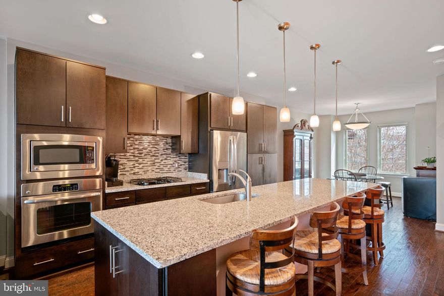 You just ran across the beautiful townhome you've been wishing for in Brambleton. A community where the concerts, brewfests, gatherings and kid friendly events are plentiful.  Built in 2011 this home still has the crisp "newer home" feeling. Your entry level first floor includes a home office that could pose as a bedroom, along with a full bath and a spacious recreation room with berber carpeting. Heading up to your 2nd floor you will find your gleaming bright kitchen with pendant lighting over the massive island, stainless steel appliances, kitchen table area, living room with a wall of windows and exit to your deck with trex-type flooring for low maintenance. The third floor brings you to your two primary suites complete with full baths and large closets. Load the vehicles into the garage, up to two, with additional parking for all of your guests. Walk with your friends over to the Brambleton Town Center to catch a movie or do some shopping. The owners of this wonderful home only caution you that the neighbors are so amazing you will never want to leave. A short rent-back period may be needed as they are having a home built.