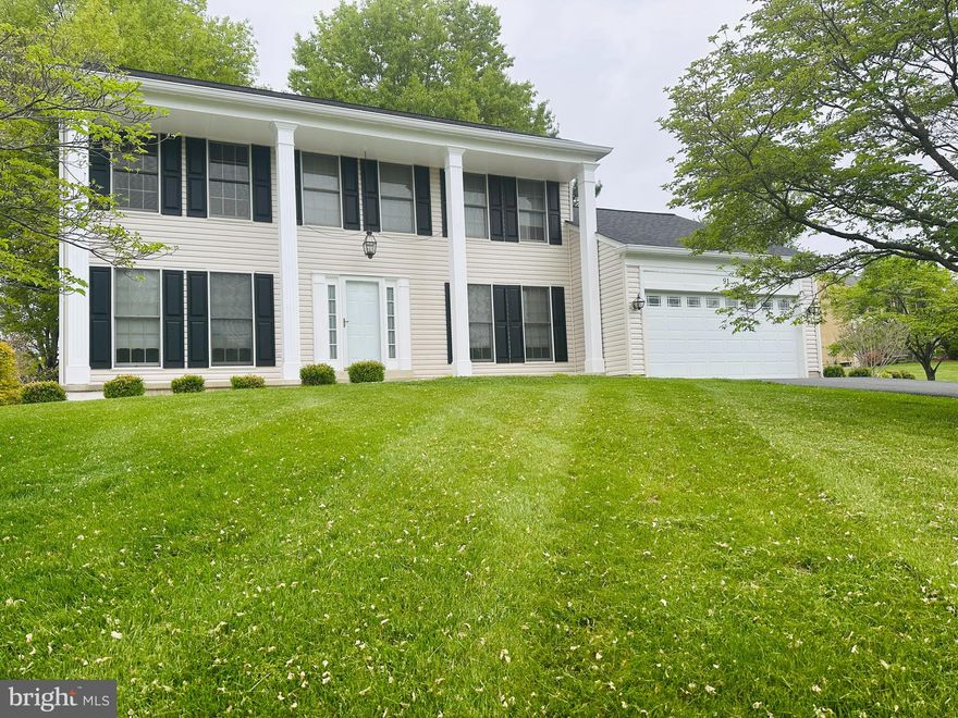 Stately 4-bedroom, 2.5-bath Colonial set on a picturesque 1.52-acre lot, offering a private and impressive approach with a long, tree-lined driveway leading to the home’s welcoming front porch with elegant pillars. This beautifully maintained property combines timeless charm with a spacious, functional layout ideal for both everyday living and entertaining.

The main level features a formal living room with wood flooring, crown molding, and abundant natural light. A private library or home office with French doors and floor to ceiling windows provides the perfect work from home retreat. The formal dining room is enhanced with crown molding, chair rail, and classic panel detailing.

The spacious family room offers a cozy setting with plush carpeting, a wood burning fireplace, and detailed trim work, with French doors leading to the deck for seamless indoor outdoor living. The kitchen features all appliances conveying, along with a bright breakfast area and additional access to the deck,  ideal for morning coffee or entertaining.

Upstairs, you’ll find four generously sized bedrooms, including an inviting owner’s suite with a walk in closet and a well appointed en suite bath featuring a soaking tub, separate shower, and double vanity. The hall bath also includes a double vanity for added convenience.

Additional highlights include a full unfinished basement with rough in for a future bathroom, offering endless possibilities for expansion, and a two car garage. Recent updates include a new roof and siding (2025), along with gutter guards for low maintenance living.

This property offers the perfect blend of space, privacy, and classic elegance, ready to welcome you home.
