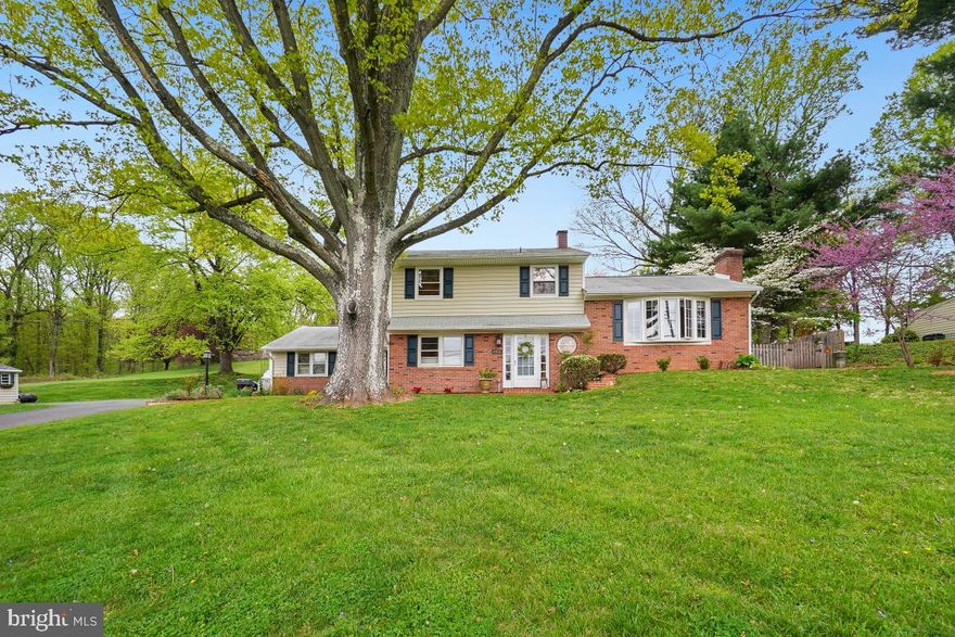 Welcome to 7516 Oakmont Dr! This stunning brick front home is located in desirable Frederick! Situated on a large .47 acre lot this home features over 3,700 square feet of living space on 3 levels. Enjoy 4 bedrooms and 1.5 baths with an enclosed carport for additional living space. The welcoming lower-level entry leads you to the huge family room with a cozy wood stove and tons of flex space or potential 5th bedroom. The family room has dual sliders letting in tons of natural light and leading you out to the huge brick patio. The main level boasts wood flooring throughout with a charming dining room including a fireplace and ample room for entertaining. The eat-in kitchen is upgraded with stainless steel appliances, tons of cabinetry, and the eat-in area leads out to another brick patio and lushly landscaped backyard. The upper bedroom level includes 4 well-appointed bedrooms with ample closet space and a full bath. There is even a bonus space in the hallway ideal for an office or hobby area. Ideal location offering privacy and a large lot while still being within minutes to shops, restaurants, and transit. Easy access to major commuter routes and Downtown Frederick. Schedule your showing today!