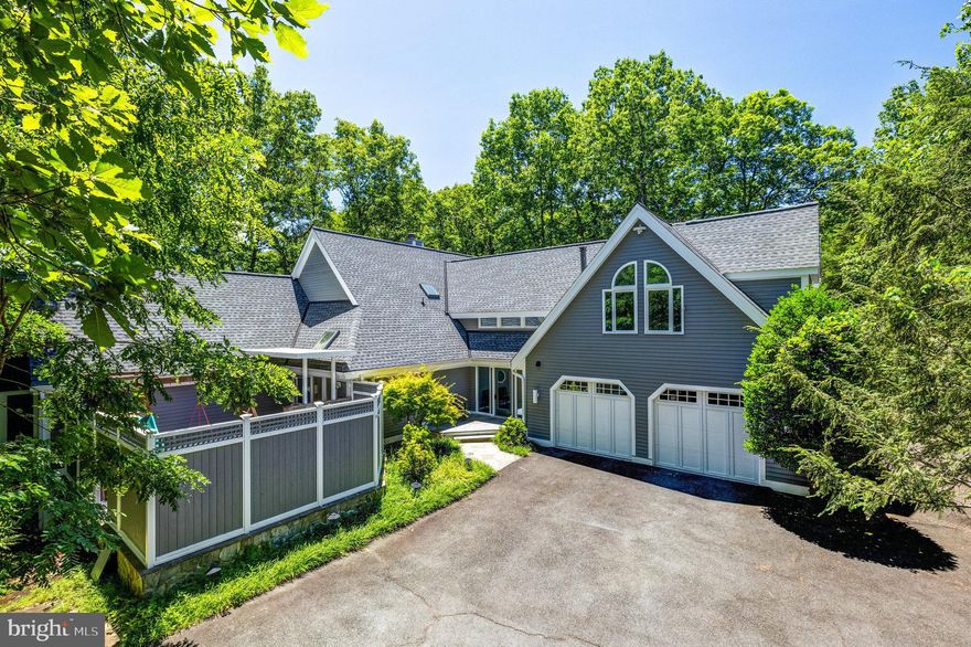 Discover an unparalleled opportunity in the heart of Reston with this stunning 1-acre wooded lot that requires no yard maintenance. This exquisite property offers a luxurious lifestyle, featuring 9 bedrooms, 6 baths, and over 7,000 square feet of living space.  The home boasts a gourmet kitchen equipped with high-end appliances, perfect for culinary enthusiasts. Throughout the house, you'll find soaring cathedral ceilings that enhance the sense of space and elegance. The upper level of this home could easily be used as a  separate apartment space with its own entrance and garage. Reston offers   nearby paths to swimming pools, tennis courts, hiking & biking trails, lakes, playing fields, and activities for every age group and interest.