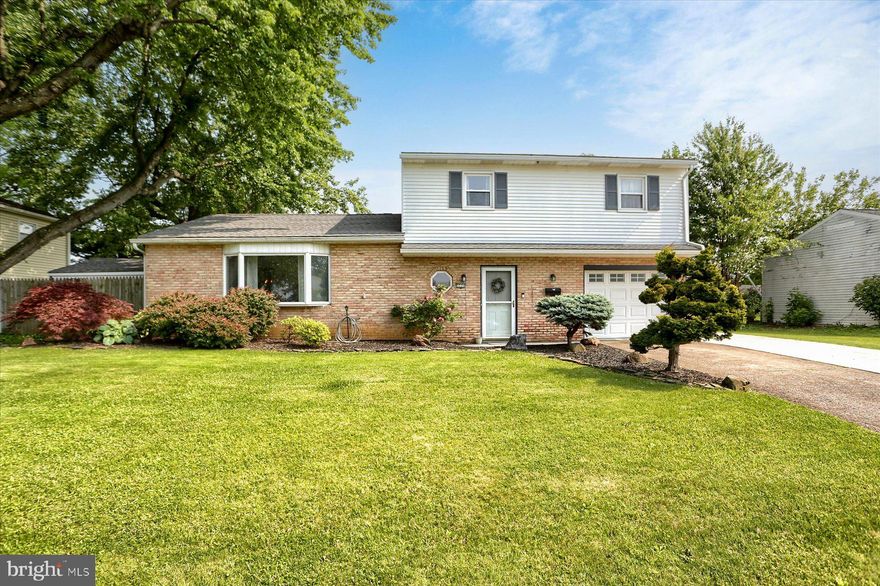 Beautiful split-level home in a quiet neighborhood, yet close to all amenities and transportation options. A bright airy home with an open feeling awaits you the minute you walk in the front door. You can walk straight into a large family room with a woodburning fireplace and wood-look ceramic tile flooring that leads into a large sunroom looking out over the backyard. This will be your summer oasis. A half bath, laundry and garage access are also on this level. Going up a few steps you enter the living room with hardwood floors and a large bay window. The dining area and a beautiful kitchen with granite countertops, tile backsplash, glass front cabinets, a double farmhouse sink, a peninsula with butcherblock top, and wine storage complete the main level. On the upper level you will find three nice sized bedrooms each with hardwood floors. The primary bedroom has an en suite and there is also a hall bath both nicely updated. The finished basement is perfect for indoor recreation or an additional family living space.