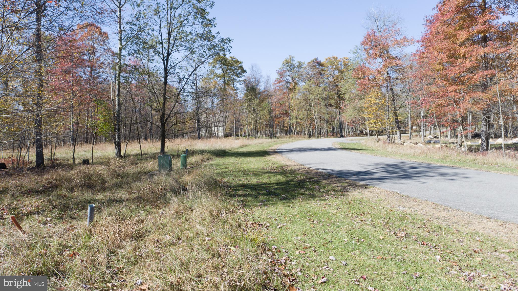 Mountain View Building Lot near Wisp Resort – This premier homesite provides almost half an acre of wooded building space in the ski-access North Camp Subdivision. Sloped grade that’s perfect for a walk-out basement, with panoramic southwestern mountain views. Evenings will become your favorite time of day at your future mountain home, as you’ll experience some of the best sunsets Deep Creek Lake has to offer! All public utilities are to site and ready to build. Contact listing agent for expert guidance on buying and building!