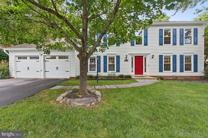 Welcome to 13057 Michie Ct — a well maintained two level colonial nestled on a quiet cul-de-sac in the heart of Lake Ridge. This charming single-family home offers the perfect combination of space, style, and privacy on a nearly half-acre, mostly level lot with expansive front and back yards. You're greeted with a brand-new front door and side lights (2025) that open into a bright, sun-filled interior featuring hardwood floors and an inviting, open layout. The kitchen is a chef’s dream with designer cabinetry, endless granite countertops, a large island with seating, and a striking copper sink — seamlessly connected to the open dining area.  There’s no shortage of living space, with both a spacious family room and a cozy living room. The living room features a wood-burning fireplace, with the chimney top rebuilt and a new flue installed in 2022. Off the living spaces, you’ll find an oversized laundry/mudroom with high-efficiency washer and dryer, leading directly to the attached 2-car garage with new garage doors (2023). Upstairs, the primary suite offers a quiet retreat, complete with a sitting area, dual vanity, and luxurious soaking tub. All bedrooms are generously sized and include ceiling fans and ample closet space. Enjoy the outdoors from two fantastic entertaining spaces: a brick paver patio off the kitchen and a new rear deck (2023) off the living room — perfect for relaxing or hosting guests in a peaceful, private setting. Located within the highly sought-after Lake Ridge community, you'll have access to an abundance of amenities: 5 pools, a spray park, 19 playgrounds, sports courts (tennis, pickleball, volleyball, basketball), community centers, trails, and more — all just minutes from shopping, dining, Lake Ridge Park, and major commuter routes including I-95, Route 1, Route 123, the VRE, and commuter lots.