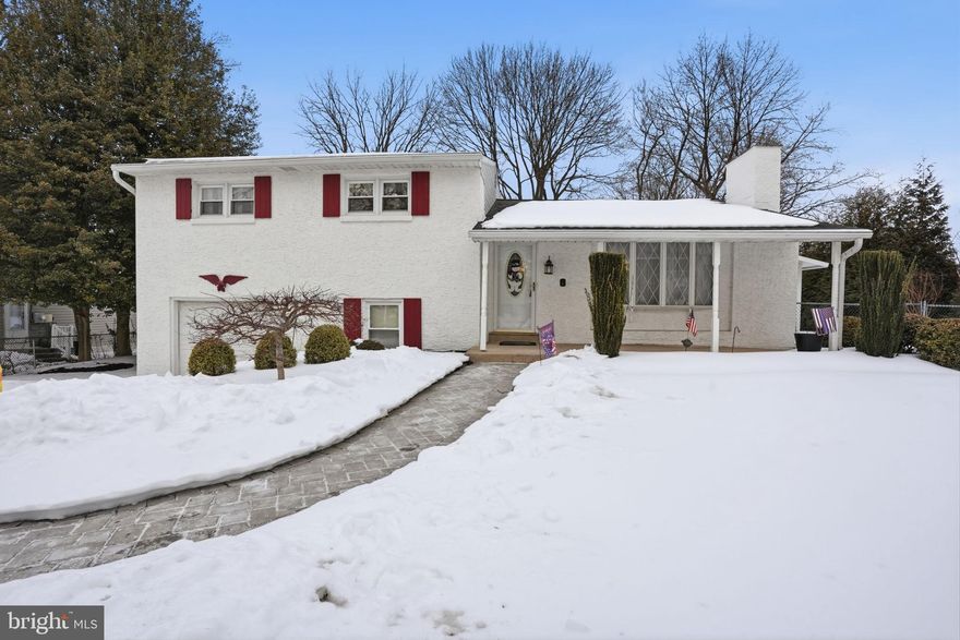 This expanded split-level home offers generous living space, thoughtful updates, and a versatile layout designed for today’s lifestyle. The main level welcomes you with a bright living room featuring a wood-burning fireplace, flowing seamlessly into the formal dining room—perfect for everyday living and entertaining alike. An impressive added family room showcases cathedral ceilings and a second fireplace, creating a dramatic yet inviting gathering space. An added sun porch provides a tranquil spot to relax and enjoy views of the outdoors. The eat-in kitchen is well equipped with a gas range, dishwasher, and disposal,  offering both functionality and comfort for daily meals. Upstairs, you’ll find three well-proportioned bedrooms, including a primary suite with its own private, updated bath. A beautifully remodeled hall bathroom serves the additional bedrooms. The lower level is fully finished and features a spacious media room, ideal for movie nights or a home office setup. This level also includes a laundry room and a convenient powder room. An additional partial unfinished basement provides excellent storage.  Additional highlights include gas heat and gas hot water, central air conditioning, a whole house generator and a one-car attached garage. This home combines classic charm with modern comforts and flexible living spaces—ready to welcome its next owner.