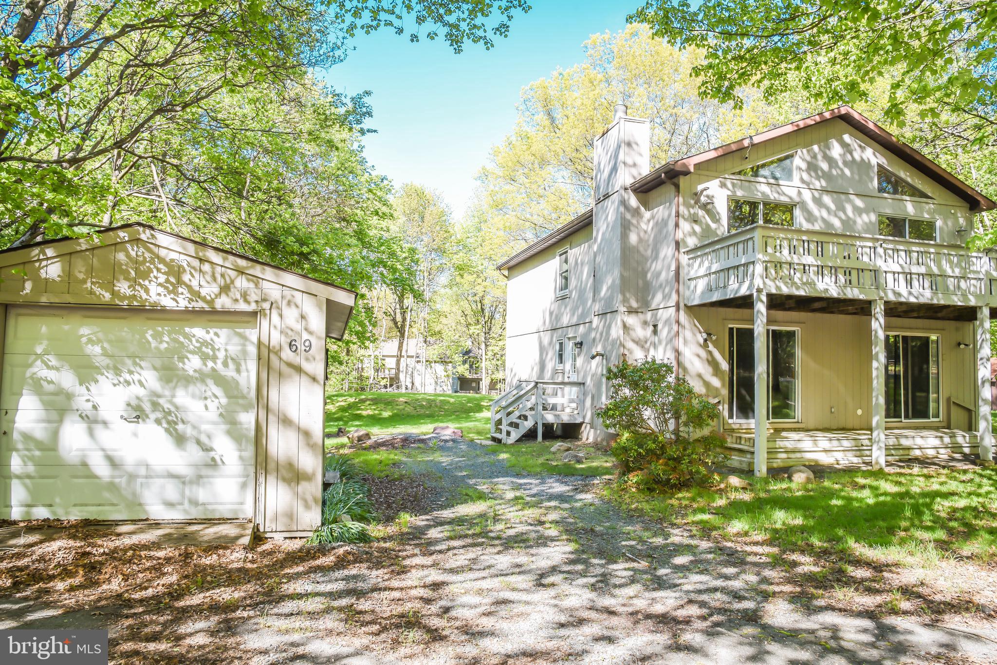 Welcome home to this amenity filled Towamensing Trails Community! Great for investment, short-term rentals or vacation home. The main entrance on the side of the home takes you into the large foyer of the main level with two bedrooms and a full bathroom, laundry room and a nice size family room with sliding doors to access the patio. Upstairs to the main level, features kitchen with dining area and living room with sliding doors leading to the large deck outside and three bedrooms with full bathroom. Close proximity to the community lake, beach, pool and clubhouse.
