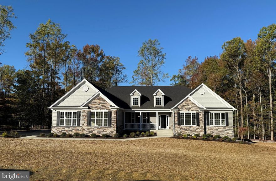 QBHI's gorgeous stone front Winchester with added gables is a favorite!  This home features a 3 car side load garage, mudroom, cathedral ceiling in owners bedroom with full bathroom, including the deluxe shower, separate vanities and soak in tub. Added rear extension for larger rooms, closets and pantry.  Gas fireplace, upgraded kitchen with Island and breakfast bar with kitchen table space and a formal dining room.  The basement is unfinished for future plans and storage.