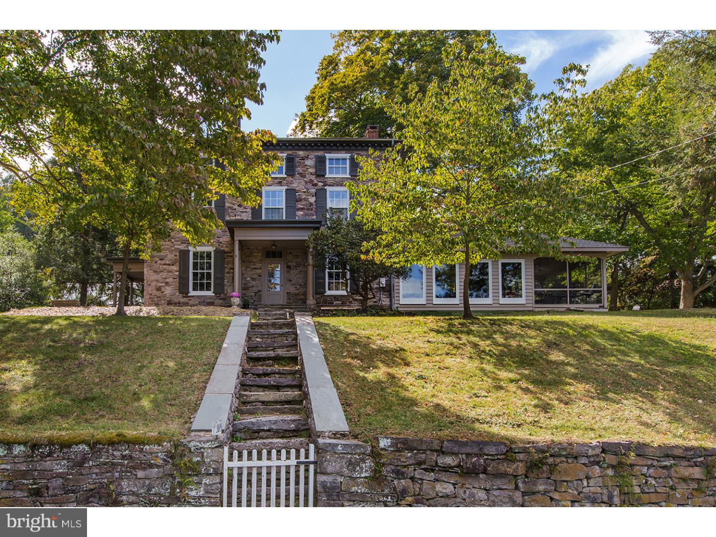 One of the most prestigious properties along the Delaware River, located in the historic village of Lumberville, is being unveiled & offered for sale in all its newly renovated glory. The c. 1850 Lukens Thomas Mansion is a Greek Revival-style manor house overlooking the Delaware River & Canal. Built by Lukens Thomas, it is on the site of Revolutionary War hero Col. George Wall's original residence. Lukens Thomas operated the retail lumber trade in Lumberville along w/ a blind, door & sash factory until 1869 when it was purchased by William Tinsman, founder of Tinsman Bros. The home remained in the Tinsman family until 2013 when it was purchased by Charles Weiler, noted owner of Kitchens by Charles Weiler in Lahaska, Pa. Weiler's 30 years of design experience seamlessly married old-world charm w/ modern amenities in order to preserve the rich historical & architectural details unique to the era. In the gourmet chef's kitchen, Weiler's main goal was to meld the design w/ the outdoor space, allowing the river to be the focal point in the floor-to-ceiling windows which make up the entire north & east walls. In addition, the cabinetry's high-gloss finish creates an understated, low-key reflection of the room's natural surroundings. The kitchen combines a classic clean-line design, traditional marble counters, professional appliances & a custom-made, one-of-a-kind range hood designed to look like it came out of an old factory. The entire house utilizes farmhouse, industrial & luxury elements. Weiler preserved & highlighted such organic features as the original stone walls of the rear foyer & fp & the pumpkin pine floors. Industrial elements were incorporated t/o the house in lighting, furniture, & countertops. Upstairs, the master & guest rooms were completely redesigned allowing for a master suite w/ private access via the rear stairs & awesome river vistas. The master bathroom is a luxury, spa-like retreat w/ a 4' x 8' shower including seven digitally-controlled shower heads. A beautiful guestroom w/ ensuite bath completes this floor. The Third floor has three addtl, spacious, sunny rooms w/ full bath. There is a new roof, new zoned climate control (including central air), tank-less water heaters & more. Redesigned outdoor spaces & landscaping complete this stunning, ready-for-the-21st-century stone house. Architectural features & amenities are too numerous to mention.