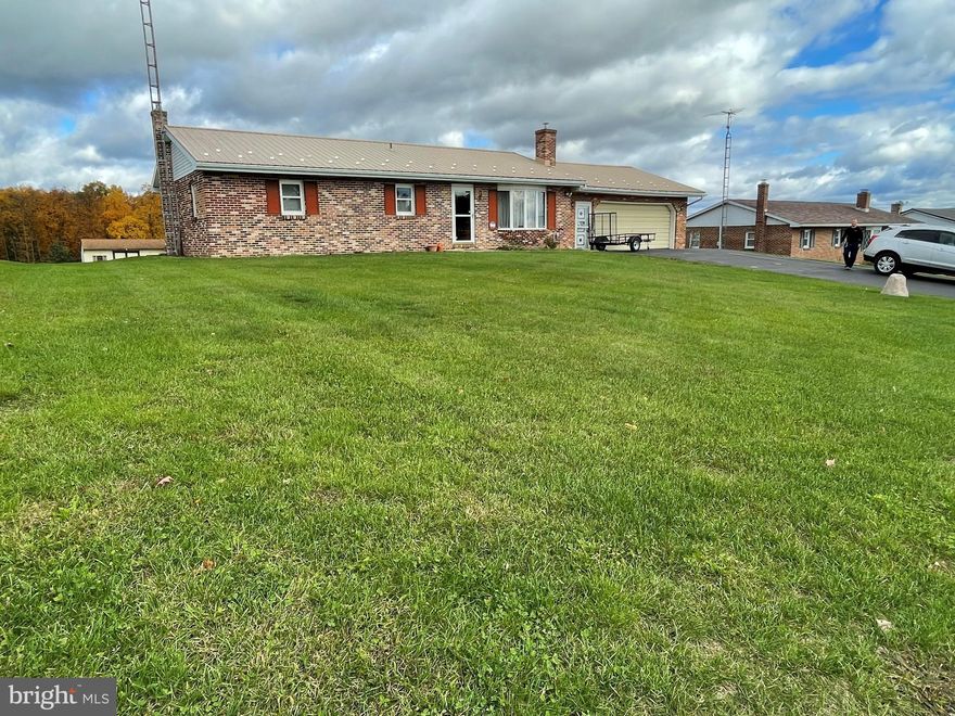 Country Setting, Mountain Views! Meticulously maintained, this all brick rancher offers ease of living on one level. Enter through the front door to the living room centered around a brick fireplace, walk through to the kitchen and past the dining room to the back porch.  Three bedrooms and a bath are down the hall.  Each room adorned with a ceiling fan. The downstairs is partially finished and a great place to shoot pool, gather around the big screen or cozy up by the recently updated pellet stove.  Take a moment to enjoy the surrounding views! From the front porch northeast you can see the mountain ranges up to the sand hills.  And the south offers views in the valley to the University and beyond! The large private back yard offers a shed and carport and is backed by fields that more than often bring in deer, turkey, and more. The attached oversized garage is large enough for at least two large vehicles and offers room for storage as well.  Another attached garage off the back can hold another vehicle or be used as a shop. 2 220 volt lines in garage for use with machinery.  So much to see schedule your showing today!