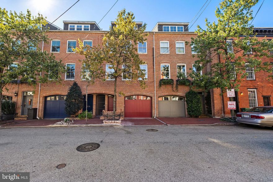 Prepare to be captivated by this stunning, luxurious residence located just one block from the waterfront. Every detail of this home exudes sophistication - from the slate and hardwood floors to the impeccable architectural features that command attention at every turn. The entry level welcomes you with a versatile space - perfect as a private office, fitness studio, or additional living area - along with a convenient half bath, access to the two-car garage, and a serene courtyard ideal for morning coffee or evening relaxation. Ascend to the main living level, where natural light floods the expansive living room through perfectly placed windows. Custom built-ins frame the space, while French doors open to an oversized entertaining deck, offering seamless indoor-outdoor flow. The chef’s kitchen is a true centerpiece, boasting a Viking Professional cooktop, Sub-Zero refrigerator, granite countertops, an elegant tile backsplash, and a substantial island that invites gatherings both casual and grand. A separate dining area completes this beautiful level. The primary suite is a luxurious retreat, featuring a private balcony with sweeping water views, a spa-inspired en suite bath with dual shower heads, a bench-seated tiled shower, and a deep soaking tub. The second bedroom offers a built-in Murphy bed, custom closets, and an en suite bath with a steam shower. The upper level hosts an additional living area, a spacious third bedroom, and a full bath illuminated by a skylight, creating a serene, airy atmosphere.Enjoy multiple outdoor spaces, including a rare elongated lot with a gorgeous stone patio and room for a fire pit - ideal for al fresco dining or cozy evenings under the stars. Recent renovations and upgrades further elevate the home’s comfort and appeal, including fresh whole-house paint, a new front door and garage door paint (2025), new tile flooring in the primary shower (2025), professional power washing of exterior living spaces (2025), a repaired brick retaining wall (2025). Additional improvements include a newer water heater, updated HVAC systems—lower level (2023) and upper level (2024)—a new dishwasher (2024), and a new garbage disposal (2022). Perfectly positioned steps from Fells Point and Harbor East, this home offers the best of Baltimore’s waterfront living—fine dining, boutique shopping, and vibrant city energy—all just beyond your doorstep!