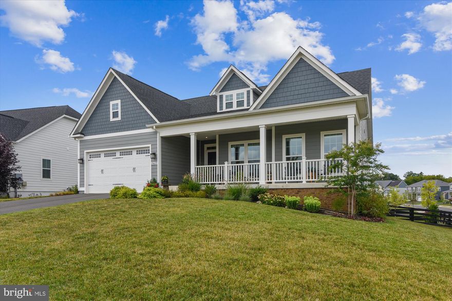 This corner lot property in the sought after Willowsford community delivers all you might expect in a planned neighborhood with an emphasis on top notch amenities. Built by Ryan Homes in 2018, this beautiful home is one of their Pinnacle Series, Carolina Place models.  
Step into comfort as you enter the gracious foyer from the spacious, covered front porch.  Let the natural light throughout the main level welcome you home.  With an open-concept floor plan, this model gives you the space you need to live and entertain family and friends.  
Hardwood flooring continues seamlessly from the foyer into the living room, kitchen, dining area, and mudroom.  The living room is the center of this home, the hub of main level living.  Appreciate the tall ceilings and archways each contributing to your gracious living experience.  White slat blinds on the bank of windows across the back of the house lend elegance to the space. 
The kitchen includes designer features in abundance with Timberlake forty-two inch white cabinetry with organization systems and base cabinet slide-out trays, large pantry, stainless steel under-mount double sink, kitchen island with bar seating, GE Energy Star stainless steel appliances including side by side refrigerator, dishwasher, built-in thirty-inch gas cooktop, microwave, and double wall oven.  Under-cabinet lighting, recessed, and pendant lights all highlight the tiled backsplash and granite countertops. 
The dining area offers natural lighting with a side view to the street and double windows to the back of the property, all with custom fabric blinds. French doors open onto the deep covered deck across the back of the home. This home gives you a place to enjoy mountain and treetop vistas with sunsets or sunrises.
The main level primary bedroom provides tray ceiling with fan and light, carpeting, white slat blinds on the windows, an extra closet and access to the back deck via French doors that have cellular shades for privacy.  Your primary bath offers a large maple double sink vanity and granite top, walk in tiled shower, separate water closet, and spacious walk in closet with organizers.
The remainder of the main level includes an extra room at the front of the house with French doors just off the foyer that can be used as another bedroom or office, a laundry room finished with tile flooring and the mudroom area with coat closet provides garage access. There is a second bedroom with multiple windows and carpeted flooring and a full bath with tub conveniently located next to it. 
Discover limitless possibilities on the lower level with a large carpeted recreation room.  There is also extensive storage space in a double closet with organizers and the unfinished storage room. Walk out from the recreation room to the paver patio, part of which is sheltered by the covered porch above.  The patio and fenced backyard has beautiful hardscaping and landscaping including a raised vegetable garden bed.
There is also the privacy and quiet of a third bedroom tucked away downstairs. This bedroom has  planked flooring and its own large closet, recessed lighting, and additional wiring for a ceiling fixture. Directly across from the bedroom is a full bath with step in shower.
The exterior provides amenities such as hose bibs and waterproof outlets, graceful landscaping, farm style oak paddock fencing, and carriage style garage doors.  The roofing warranty conveys on the Tamko 30 year Architectural Roof Shingles.
Don’t miss the amenities at Willowsford.  Bocce and volleyball courts, canoe dock and rentals at Willow Lake, dog park, community park and pavilion, fire pit, playground, two resort style swimming pools and pool house, community center, fitness center, twenty mile network of bike/hike trails, boat house and lodge and so much more!