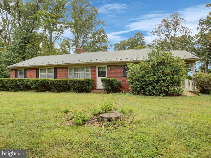All brick rancher with three bedrooms, one bathroom, situated on 1.93 acres along the mountain, surrounded by mature trees. This home features an eat in kitchen, a brick fire place, and hardwood floors throughout. The basement includes a two car garage for added convenience, plenty of room for a workshop as well. Several outbuildings and carports provide additional storage and utility space. 
Being sold AS IS, this property offers exceptional potential to create an ideal retreat.