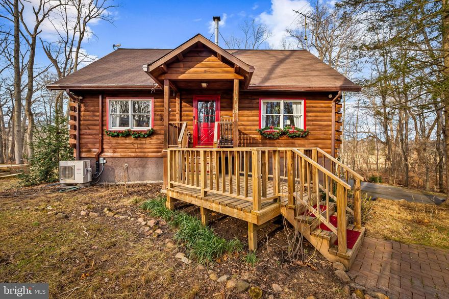 Tucked away at the end of a long meandering driveway, this charming custom storybook, by  Northeastern Log Homes, was built on site. It is constructed of White Pine, Spruce and Douglas Fir and offers rare privacy,  just minutes from shopping and entertainment.  Built in 1985 and expanded and updated in 2023 with thoughtful design and functionality. This 3 bedroom, 2.5 bath home offers 2034  square feet above grade of charm, special features and beauty.  The lower level increases the square footage of the home to approximately 2734  square feet total. The light filled foyer greets guests with with a warm wood stove and custom designed staircase and overlook.   The spacious main level offers light filled living room with, large custom windows, gorgeous hardwood floors and exposed beams.  There is a  new large half bath in the hall just off the living room for guests. The Dining Room has two huge windows, taking in the views,  and  was designed with a large room dividing, custom builtin storage piece, whose storage can be accessed from both the Kitchen and the Dining Room. The spacious kitchen has room for multiple chefs. The stainless steel appliances are worry free. The propane stove is brand new and the refrigerator and dishwasher a few years old.  Just off the kitchen there are three multi level decks. The first, just outside the kitchen door,  is a great place for coffee. The second deck,  down a few stairs, is a larger space that could be the perfect place for an alfresco dinner party. And the final deck, is a large space to entertain, in the spring, summer or autumn either with a firepit, or seat a huge group for dinner!  Each deck invites you to, relax and entertain guests, in style, in complete privacy. The Primary Suite retreat is also on the main level. Featuring a new sun filled office, over looking the grounds, a large 4 piece primary spa bath and spacious walk in closet, Custom soaking tub,  large custom tile shower, all with heated  tile floors.  Upstairs you will find two large light filled bedrooms with vaulted beamed ceilings separated by a large overlook and updated  3 piece full bath with tub shower combination. The lower level offers multiple spaces to relax , spread out and have fun. The spacious family room, with Cork flooring, is perfect for movie night.  It could easily hold a large screen TV and sectional so everyone can enjoy.  There is another large room with gorgeous custom floor and large builts in,  currently the owner, uses it as a custom pantry/ craft room. However this could easily be a large second office or great exercise room. Really whatever works for you.  This level also has a large separate laundry room and direct access to the new attached garage. Just off the garage there is an additional space ideal for storage or a workshop. Peaceful, private yet convenient to everything you need, with a home that offers the perfect blend of storybook charm and smart functionality. Roof is 6 years old. Ductless systems  throughout the home are 2 years old. There are (2) 60 gallon, seller owned, Propane tanks, that transfer and a generator that comes on automatically when the power goes out, that covers the well, hot water heater, refrigerator, and electric throughout the home.