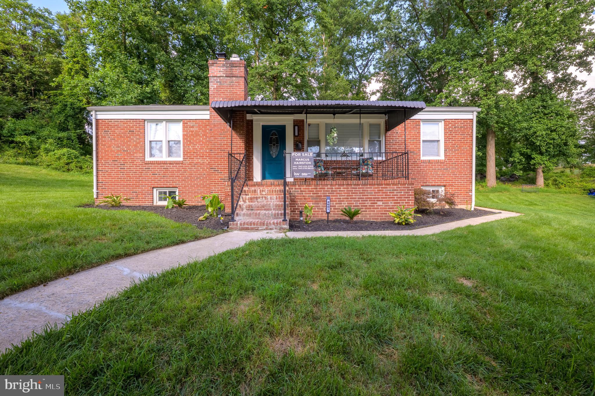 Welcome to “The Serenity” an exquisite all brick family home located at 2601 Royal Oak Avenue, Baltimore, Maryland 21207 sitting on almost an acre of well-kept landscape. Don’t miss this astounding opportunity to own this updated home with 5 bedrooms, 2 full bathrooms,and refinished hardwood floors throughout in the sought after community of Gwynn Oak Neighborhood of Howard Park. This home promotes serenity and peace from the moment you pull into its excessively long driveway or designated space directly in front. Walk up the pathway to the large front porch perfect for enjoying your morning coffee, relaxing and or just enjoying the sounds of nature outdoors. Enter the large living room with hardwood flooring and a huge picturesque window that brings lots of natural light. The adjacent dining area with a unique retractable ceiling fan has enough space for formal dining or everyday casual family meals. Monitor kitchen activities from the opening in the dining room or step directly into the large remodeled kitchen that features granite countertops, stainless steel appliances, gas stove and recess lighting. As you exit through the kitchen door, come outside for the perfect opportunity to enjoy grilling out and entertaining on your large newly stained deck.
This home features a spa-like bathroom with a jacuzzi tub, sprayer shower head and open base vanity for storing your towels or other personal items. Step into three spacious bedrooms on the first level. Bedroom one is located directly across from the bathroom. It is huge with lots of closet space, a large picture window and an extra side window to enjoy all the wonderful nature views from inside. Bedroom two sits next to bedroom one and the bathroom. Bedroom three is slightly smaller, but has plenty of room for bunk beds, office, or even a hobby area with built-in closet space. Walk downstairs to your finished basement with two more bedrooms, another full bathroom and lots of additional spaces for sports entertainment, home office, movie area, storage and/or even a home fitness gym with walk-out access.
This amazing property features a variety of outdoor spaces. You have a plethora of off street parking for 6 or more cars. If you have a trailer, RV, or boat, this home provides the space needed to store these onsite. Enjoy your fire pit out back with friends or your huge park-like setting in this landscaped yard that backs up to the golf course while watching the deer. Get all this on a lot that provides plenty of private space for family gatherings, entertaining, BBQs or relaxing evenings. This is nature at its best in a hidden area of Baltimore City!
Conveniently located near major highways, I-695, I-70, I-83, and I-95. shopping, local attractions, and major universities, this home is in the perfect location that combines quiet city living, with an incredible amount of serenity! This large open space and peaceful neighborhood is unbelievable for a city property. Schedule a showing today and experience the true essence of refined living!