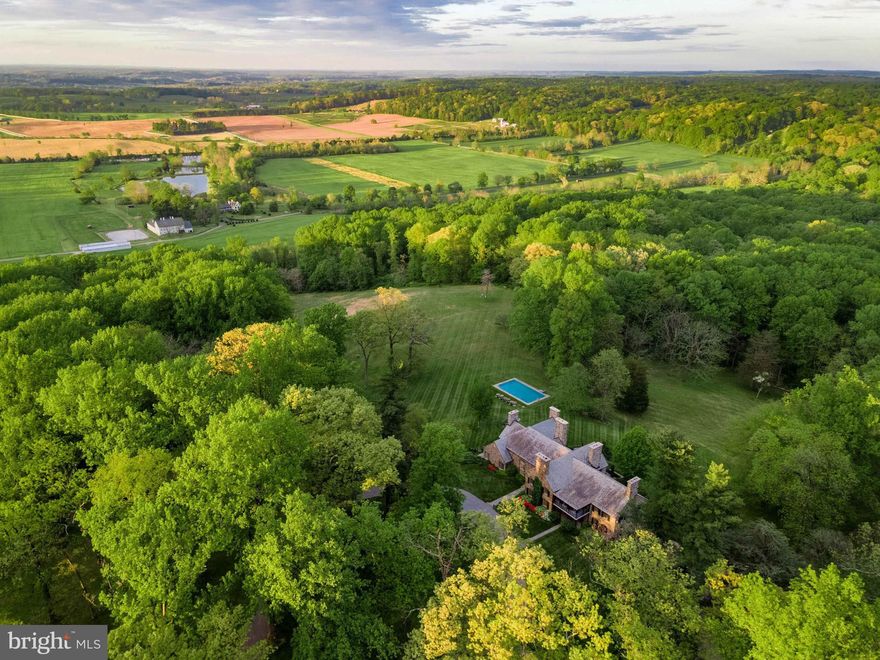 Live authentically. Magnificent stone estate tucked away overlooking Worthington Valley and beyond. Upper Melinda awaits perched on 235.00+/- acres. Commanding views of the valley complement the strength  grandeur of this enduring architectural masterpiece. Relish the meandering drive home through lush  woodlands. A sanctuary of tranquility and serenity. Crafted by acclaimed architect Louis McLane Fisher and adorned by the legendary Baltimore native, Billy Baldwin. Discover the whispers of Baldwin’s timeless touches lingering in dashes of red lacquer accents and smokey mirrors throughout. Within,  nine roaring fireplaces beckon conversation and radiate comforting warmth. Main level owner’s suite. Transform your nocturnal journey as you gaze across the valley before falling into restful slumber. Your inner chef will flourish in the cooking space. Partake in lighthearted fun and competition in the basement game room. Original cork flooring embellished with exotic animal inlays; intact. Immerse yourself in the opulence of rich landscaping as you explore your outdoor haven. Savor the stillness and go for an invigorating round of laps in the sublime pool..  Recharge in the ambiance. An expansive stone terrace embraced by abundant greenery beckons for an elevated outdoor dining experience. Other worldly views that are hard to grasp.  A palpable depth of wonder permeates.  A sensory experience. Vistas that mirror paintings. Gaze over glistening ponds in the distance. Truly a living canvas from which to paint the next chapter of your life. A legacy property. 5 +/- miles of  extensive trail network throughout the grounds. Revel in the extreme privacy.  Indulge in the vast beauty that unfolds around you. Enchanting stone guest house recently renovated.  Four income generating tenant houses convey that are unable to be divided. Cultivate your existence. The art of uniting human and home. Do not drive to property without an appointment. Property is subject to conservation easement.