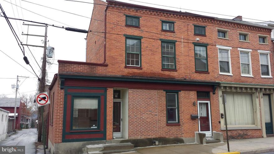 INVESTORS TAKE NOTE...renter in place upstairs to help buy the building. Downstairs commercial space open for your creativity. Approx 900 Sq. feet includes 2 rooms, 1.5 baths, kitchen, lobby area, small courtyard out back. Rent income is $750 per month (desire is to stay but is on M2M). Gas heat, one parking space, large front display window.....and right across from Columbia Market House makes this a great possibility for store, office, etc.