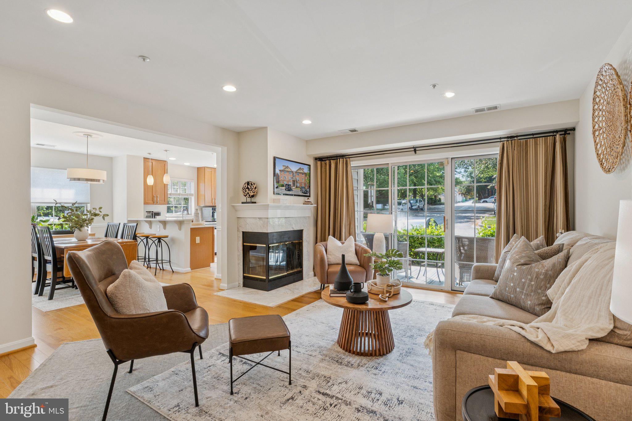 Welcome to this recently updated two-bedroom, two-bath, terrace-level residence in the sought-after Kentlands View Condominium community. A desirable corner unit, this home is bathed in natural light throughout the day and has been freshly painted and thoughtfully updated to blend modern comfort with timeless style.
The open-concept floor plan features a beautifully renovated kitchen appointed with sleek cabinetry, quartz calacatta countertops, stainless steel appliances and a generous breakfast bar with pendant lighting and additional seating, ideal for casual dining or entertaining. The dining area flows effortlessly into a spacious living room anchored by a wood-burning fireplace and offering direct access to a private patio, creating a seamless indoor–outdoor living experience.
The serene primary suite includes a renovated en-suite bath with a walk-in glass enclosed shower, dual vanities and a custom-designed walk-in closet. The well-proportioned second bedroom features brand-new carpeting and access to the adjacent full bath, making it perfect for guests or a home office. Additional highlights include custom closet systems throughout, in-unit laundry with a full-size washer and dryer and ample storage space.
Nestled in the heart of Gaithersburg, The Kentlands is a nationally acclaimed neighborhood emphasizing walkability, community engagement and architectural charm. The community features a rich blend of residences, schools, parks, and green spaces, all centered around a lively town core. Residents enjoy a full calendar of events, ranging from open-air concerts to seasonal festivals and 5Ks, alongside unparalleled access to recreational and lifestyle amenities such as leisure and lap pools, pickleball and tennis courts, basketball courts, a state-of-the-art fitness center and a newly updated playground. The residence is also conveniently located near major commuter routes, including I-270 and Route 28, providing excellent regional access. With its welcoming atmosphere, exceptional convenience and enduring appeal, The Kentlands offers a distinctive quality of life rarely found in suburban settings.