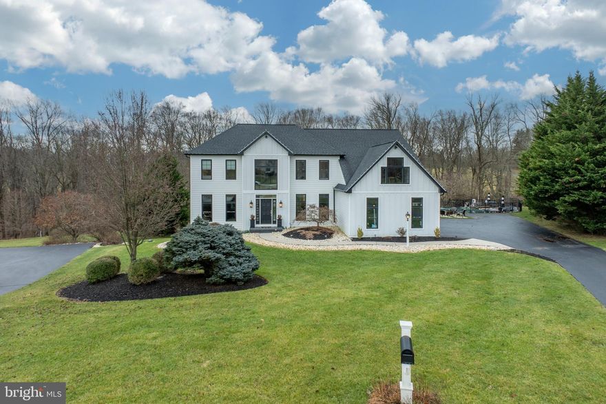 Nestled at the cul-de-sac end, this stunning Chester County home is a sanctuary, embraced by serene farmland and babbling brooks. With just under an acre of private land, this haven boasts an in-ground fenced pool and spa, accompanied by a modern Farmhouse-styled concrete back porch designed for seamless entertainment, complete with a TV hook up and refrigerator. Overlooking open land, a picnic bench invites summertime daydreams and leisurely picnics. Descend to the walkout basement's patio, where a fire pit beckons for s'mores and captivating gatherings.
The exterior reflects meticulous attention to detail, having undergone a complete stucco removal, now clad in Grade A Hardy Board Planks. Tasteful black-tinted frameless Okna windows adorn the structure, complementing natural wood accents on each porch, accompanied by rustic brushed bronze Restoration Hardware light fixtures. A three-car garage, donning farmhouse doors and tin roof accents, adds rustic charm.
Enter through the front door to encounter soaring cathedral ceilings adorned with a breathtaking chandelier. To the left, discover a private pub area embellished with a custom-built bar and elegant built-ins. On the right, the freshly painted dining area features glossy chair rail picture-framed woodwork on wide-planked chestnut maple wood flooring.
Adjacent, a designer gourmet kitchen beckons with leathered granite countertops, an oversized porcelain farmhouse sink, and Bosch appliances. White Cherry Amish made cabinets and white wide plank Shiplap grace the walls, culminating in an oversized island crowned with white quartz countertops and a custom-made Live Edge coffee bar. There is a countertop gas stove with a stainless steel hood and a GE double oven for all your holiday meals.
The expansive great room invites with a floor-to-ceiling stone hearth fireplace and an industrial-style ceiling fan, basking in natural sunlight through rounded windows. An adjoining spacious private office and an updated half bath complete the main floor.
Ascend the turned staircase to find new wide-planked hardwood flooring adorning the upper level, which hosts three spacious bedrooms sharing an updated full bath with quartz double sinks.  The wide open hallway highlights the architectural uniqueness and functionality of the custom-made columns and the charming double-sided pocket door, emphasizing their ability to create a versatile living space that caters to both openness and seclusion as needed.
The primary bedroom unveils a haven reminiscent of a spa retreat, adorned with a captivating wide-plank accent wall and an adjacent space perfect for a private workout area or a serene office enclave. An inviting sliding barn door conceals the entrance to the newly renovated bathroom, a picturesque sanctuary offering uninterrupted views of the rolling farmland and tranquil brook.
Within this tranquil space, a freestanding soaking tub takes center stage, positioned to offer a serene vista of the surrounding landscape. The luxurious experience continues with a sprawling, seamless glass-door shower, boasting dual shower heads for a lavish bathing indulgence. A thoughtful addition, a separate water closet, enhances the sense of privacy and exclusivity within this sumptuous haven. Returning downstairs, the walkout full-light basement unveils an apartment or in-law suite, exuding an industrial ambiance. With a full bedroom, office or craft room, a full bath, a half kitchen, and a sprawling entertainment/living area, this space offers versatility and ample storage.
Beyond its captivating interiors, this home boasts a new roof, gutter system, water heater, pool pump, well pump, and dual-zone HVAC, presenting an opportunity for turnkey living.

This Home has been pre-inspected and reports are available upon request after 1/13