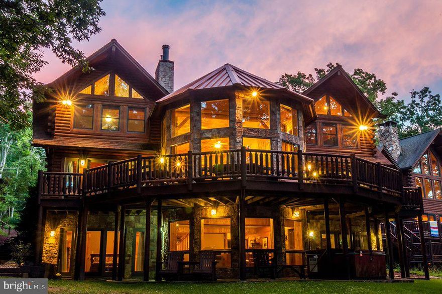 Stunning Lakefront Masterpiece! This expansive log home offers nine bedrooms (5 en suites), an open floorplan, hardwood flooring, floor-to-ceiling stone fireplace, cathedral wood ceilings and granite countertops. The abundance of windows brings the beauty of the outside in during any season. Three levels of living space and large open rooms make this home the perfect spot to enjoy family and friends. The outside area is just as pleasing…boasting a large deck, hot tub and an easy path to the Type A dock. The central location is one more plus – just minutes to DCL State Park, Wisp Ski Resort, restaurants, shops, cinema and grocery stores. This home truly checks off all the boxes from the moment you walk in. Established rental “Sunset Delight” grossing $240,000 already in 2022.