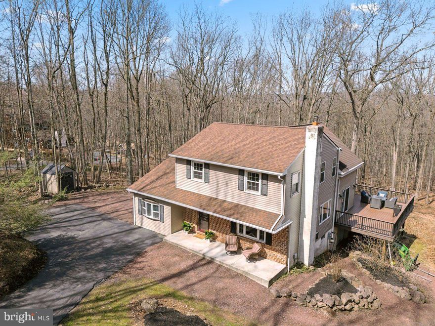 Multiple offers received. Please submit highest and best offer by Thursday, March 26 at 9PM for replies Friday, March 27. 
Welcome home to your new retreat in the woods! This hidden gem offers 3 bedrooms (4th possible), 2 full bathrooms, and 2 half-bathrooms on 2  acres in "Briarwood", Berks County.  Enjoy the warmth of the wood stove with brick hearth in the living room. New hardwood floors throughout the first floor enhance the open space of the kitchen and great room with many windows bringing in lots of sun light.  The kitchen brings solid maple cabinets with significant storage and a huge island. Gas fireplace in the great room. 
A wall of glass doors in the great room extends the living space onto the expansive patio with covered gazebo (included in sale) and composite decking for low maintenance.  Relax on the patio that was built for entertaining family and friends, and overlooks two acres of woods in the back yard.
Next to the kitchen is a laundry room/mud room area complete with closets and storage cabinets. (washer & dryer included).  A door leads to the side yard making  this area a perfect "drop zone" for shoes, backpacks, and bringing in groceries. Completing the first floor is a bonus room that is ideal for an office,  playroom, or 4th bedroom.

On the 2nd floor you'll find 3 bedrooms. The spacious owner's suite captures the sunlight with a custom window, and incorporates an attached bathroom oasis. A full hall bath and 2 other bedrooms complete the upstairs with new hardwood floors.
Like to entertain? The finished basement is a fun zone, complete with a great bar area.  Just add several stools and a TV and you'll be ready to watch football or your favorite sport! The rest of the walk-out basement includes the utility room, half bath,  and the attached one-car garage.
Storage sheds add extra space for everything you need!
Located within a few miles from everything... turnpike exchange, restaurants, Morgantown shopping plaza,  French Creek State Park, and major routes (Route 23, 100, 401, 82).  Roof replaced 2020; replacement windows; 2025 gutter guard; 2025 hardwood floors throughout.