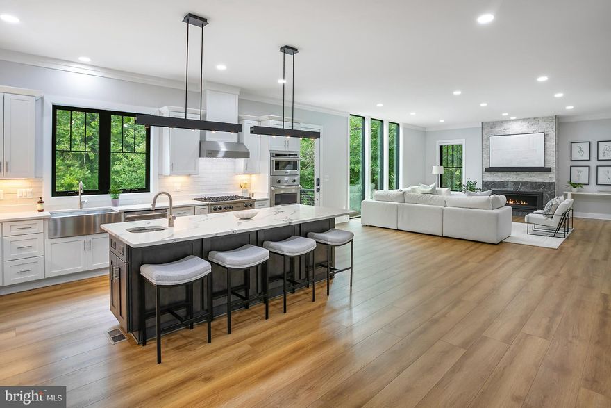 Discover the epitome of modern luxury in this stunning residence located in the Town of Vienna. This home is nestled on a 0.49-acre lot of lush greenery and enhanced landscaping that backs to a reserved park area creating a private oasis. Built in 2021, this 7,253-square-foot home offers a perfect blend of elegance and functionality.

With 8 spacious bedrooms and 6.5 bathrooms, the home features 10-foot ceilings on the main level, enhancing the sense of space and light. Enjoy the convenience of two primary suites, one on each floor, and dual laundry facilities strategically located for ease and efficiency.

The home boasts two expansive outdoor areas perfect for relaxation and entertainment. The basement, featuring large windows, provides ample natural light and picturesque views, creating a serene retreat.

Custom features include unique window designs in the living room and staircase, and a gourmet kitchen with an oversized island and Viking appliances. The primary suite features tray ceilings, while the dining room is adorned with coffered ceilings, craftsman trim, and crown molding, showcasing exceptional attention to detail.

Modern systems such as two sump pumps and a 75-gallon water heater ensure comfort and reliability. Quaker and Anderson windows offer both aesthetic appeal and energy efficiency, while generous storage is available throughout the home.