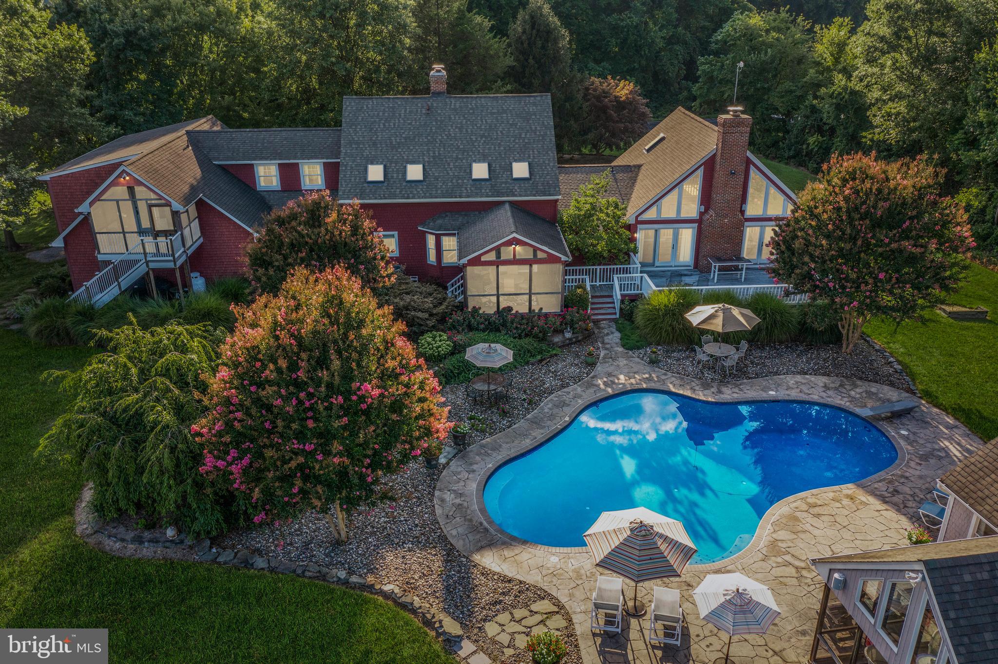 Almost 40 Acres nestled in a serene setting in the quaint town of Queen Anne, and just around the corner from amenity-rich Tuckahoe State Park, this 5 bedroom, 4.5 bath Custom Farmhouse Retreat boasts scenic views from every room. Upon entry of the 4400+ sq. ft. home, the open concept Living room, Dining room, and Kitchen flow toward a Screened-in Porch overlooking the Gunite Pool and beautifully landscaped grounds. Upstairs in the Main House are three additional Bedrooms and another full Bath. The main level also consists of an expansive Family room with cathedral ceilings and a free-standing Wood Stove, a Primary Suite with a luxurious Bath, a huge Walk-in Closet, a Private Office, and Loft Space. Above the oversized attached 2 Car Garage, is an In-Law Suite with a Bedroom, full Bath, Living room, and Kitchen, complete with a Separate Entrance and Screened Porch. Overlooking the 33,000-gallon Saltwater Pool is a Pool House with Kitchenette, Full Bathroom, Screened Porch, Outdoor Shower, and Storage Area surrounded by lush Landscaping and a spacious Pool Deck, making this home the ideal place to entertain guests. The Backyard also has a detached Barn with 2 stalls, a Run-In shed, and 2 other separate storage areas. With the adjoining lot, this property boasts 39.27 acres of privacy combined with fishing, boating, riding, hiking, skill course, camping, Adkins Arboretum, and biking in Tuckahoe State Park providing countless ways to enjoy Maryland's natural environment. This fantastic property is within an hour's commute to Baltimore, DC, and Rehoboth! Don't miss this opportunity to make this amazing Retreat your own! HOME IS ALSO LISTED SEPARATELY. SEE MLS #MDCM2002082 and See the Farm Listing #MDCM2002474