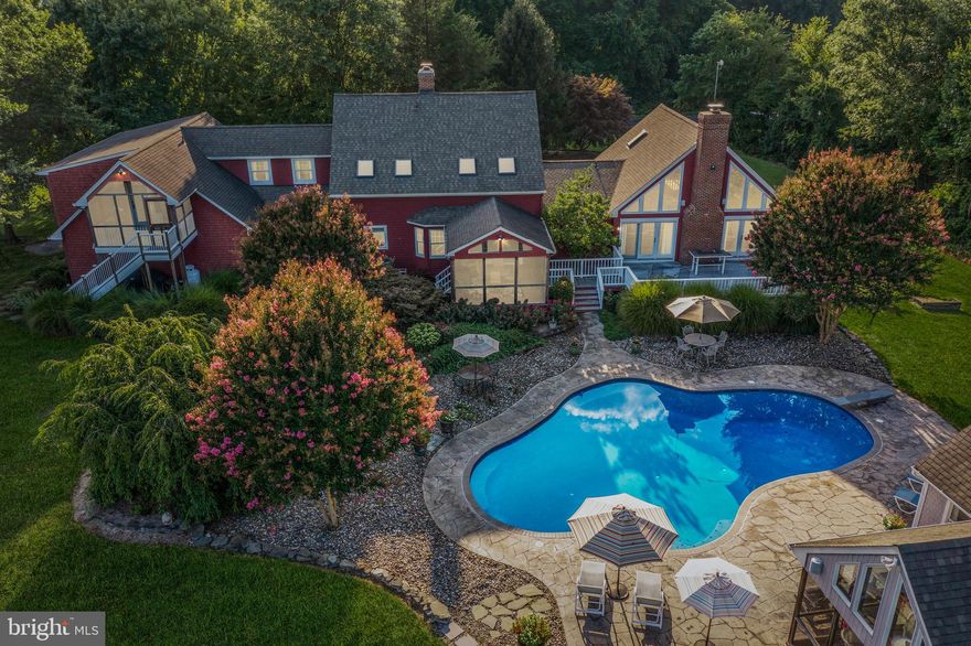 Almost 40 Acres nestled in a serene setting in the quaint town of Queen Anne, and just around the corner from amenity-rich Tuckahoe State Park, this 5 bedroom, 4.5 bath Custom Farmhouse Retreat boasts scenic views from every room.  Upon entry of the 4400+ sq. ft. home, the open concept Living room, Dining room, and Kitchen flow toward a Screened-in Porch overlooking the Gunite Pool and beautifully landscaped grounds.  Upstairs in the Main House are three additional Bedrooms and another full Bath.  The main level also consists of an expansive Family room with cathedral ceilings and a free-standing Wood Stove, a Primary Suite with a luxurious Bath, a huge Walk-in Closet, a Private Office, and Loft Space.  Above the oversized attached 2 Car Garage, is an In-Law Suite with a Bedroom, full Bath, Living room, and Kitchen, complete with a Separate Entrance and Screened Porch. Overlooking the 33,000-gallon Saltwater Pool is a Pool House with Kitchenette, Full Bathroom, Screened Porch, Outdoor Shower, and Storage Area surrounded by lush Landscaping and a spacious Pool Deck,  making this home the ideal place to entertain guests. The Backyard also has a detached Barn with 2 stalls, a Run-In shed, and 2 other separate storage areas.  With the adjoining lot, this property boasts 39.27 acres of privacy combined with fishing, boating, riding, hiking, skill course, camping, Adkins Arboretum, and biking in Tuckahoe State Park providing countless ways to enjoy Maryland's natural environment.  This fantastic property is within an hour's commute to Baltimore, DC, and Rehoboth!  Don't miss this opportunity to make this amazing Retreat your own!  HOME IS ALSO LISTED SEPARATELY.  SEE MLS #MDCM2002082 and See the Farm Listing #MDCM2002474
