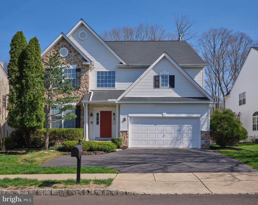 Welcome to 204 Riverwoods, ideally located within walking distance to New Hope Boro and the scenic Delaware River in the highly sought-after Riverwoods community of New Hope. Nestled on a premium lot backing to tranquil woods, this expanded “Summit” model offers more square footage than most, providing exceptional living space both inside and out. Step into the dramatic two-story foyer, highlighted by beautiful millwork and hardwood flooring that extends throughout most of the first floor, all complemented by fresh, neutral paint throughout. To the left, a formal living room with crown molding and front-facing windows offers an elegant setting, flowing seamlessly into the formal dining room—perfect for entertaining. The heart of the home is the expansive eat-in kitchen, featuring new stainless steel appliances, granite countertops, a center island, breakfast bar, large walk-in pantry, and a spacious breakfast area overlooking the private, wooded backyard. The kitchen opens to a stunning, light-filled family room with a gas fireplace and a wall of windows that frame picturesque views of the deck and serene landscape. A powder room, walk-in coat closet, and direct access to the garage complete the main level. Upstairs, an oversized hallway and open landing overlook the foyer below, leading to four generously sized bedrooms, an updated hall bath, and the convenience of second-floor laundry. The luxurious primary suite is a true retreat, boasting vaulted ceilings, dual walk-in closets, and two separate sitting areas, including one with access to a private balcony overlooking the peaceful backyard. The renovated primary bath features a new shower and dual vanities. The finished basement is the crown jewel of the home, offering an expansive open layout ideal for a game room, media room, entertaining space, or all of the above, while still providing ample unfinished storage space. Additional upgrades include a new roof, new gutters with leaf guards, new garage door openers, a new ADT security system, professional landscaping with outdoor lighting, and new window treatments. Enjoy the best of both worlds—peaceful suburban living in a beautiful neighborhood with the convenience of walking into town, exploring New Hope’s vibrant dining and shopping scene, or taking a scenic stroll along the canal towpath.