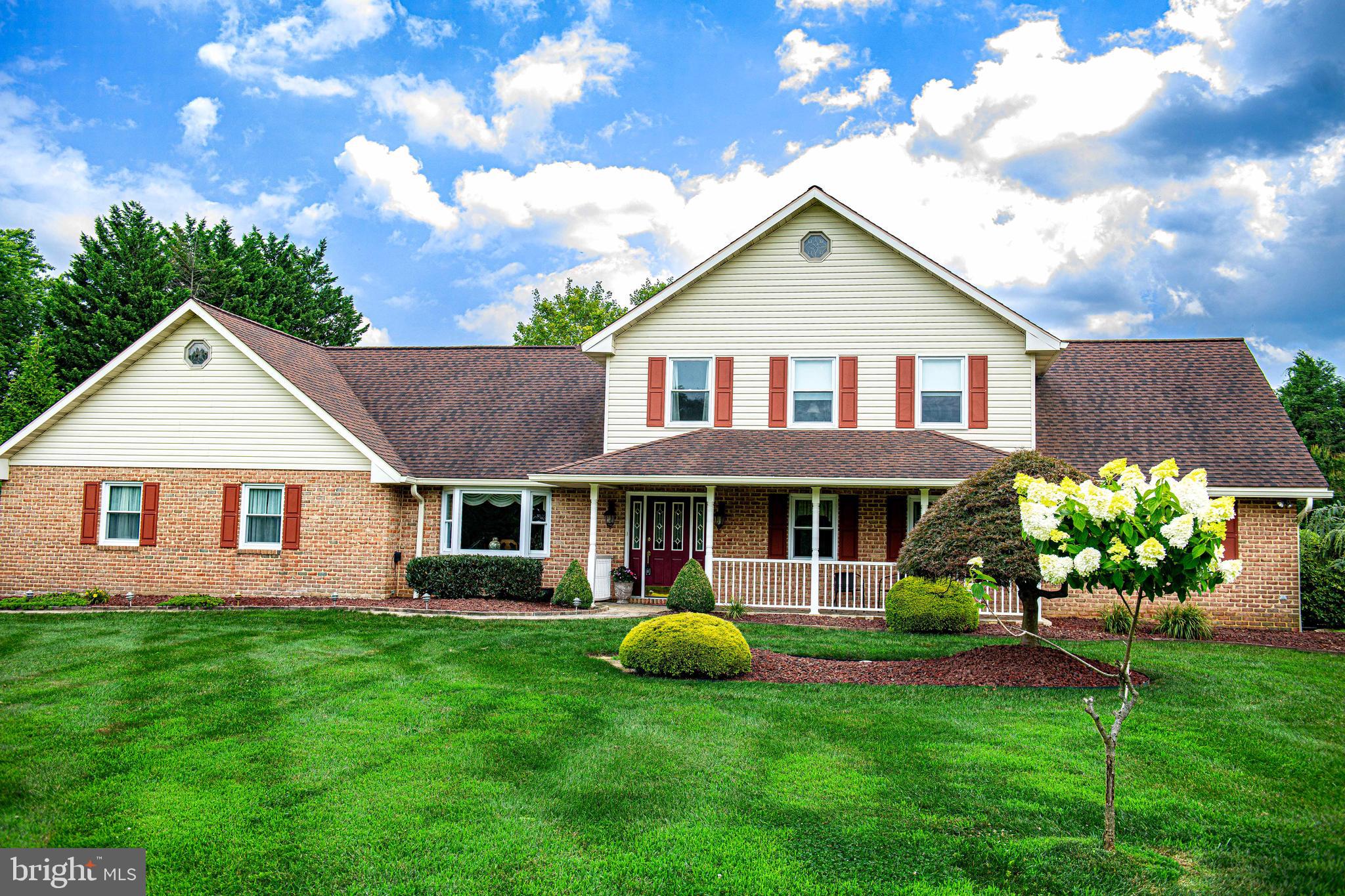 Welcome to this spacious and beautifully maintained 4-bedroom, 2.5-bath home situated on 1.94 acres of serene landscape. With generous living spaces, modern updates, and a thoughtful layout, this home offers both comfort and flexibility. Step into the inviting foyer featuring hardwood floors and an entry closet, with the formal dining room to the left and the living room to the right. The dining room is oversized and elegant, featuring crown molding and chair rail detailing. The living room offers great natural light and is a perfect space for entertaining or relaxing. The kitchen is a dream for any home chef, complete with tile flooring, a large island with cooktop, double wall ovens, custom cabinetry, granite countertops, and big windows that fill the space with light. There’s also an eat-in area for casual meals. Open to the kitchen, the family room includes a wood-burning fireplace, crown molding, and large doors that lead to a screened-in patio—ideal for indoor-outdoor living. The main level continues with a spacious primary bedroom offering a large walk-in closet. The attached bath includes double sinks, a huge jetted tub, a separate shower, and multiple additional closets, including a linen closet. A convenient powder room is located off the laundry area, and the oversized laundry room includes pantry space and access between the kitchen and garage. Upstairs, you'll find three generously sized bedrooms—each with ceiling fans, fresh carpet, and double-door or walk-in closets. A shared hall bath includes a tile floor, single vanity, and a tub/shower combo. There's also an additional finished room on this level, currently used for storage, that could easily be converted into a fifth bedroom or bonus space. The full basement is massive, waterproofed, and unfinished—ready for future expansion or ample storage. The 2.5-car garage offers additional storage above and direct access to the basement. Outside, enjoy the large ground-level trek deck and screened-in patio, which is insulated should you wish to enclose it. Additional features include a whole-house generator (excluding oven and cooktop), a heat pump with propane backup (upper-level unit replaced in 2024, lower level in 2020), a 50-year roof that is approximately 10–12 years old. This home offers space, comfort, and versatility—all in a peaceful setting.
