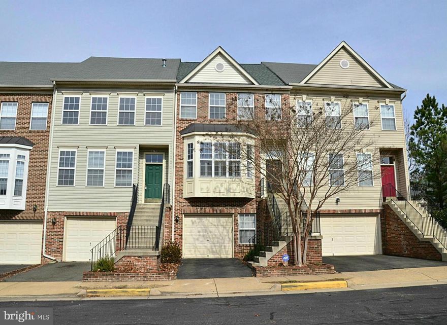 Spacious brick-front townhome with garage boasts an enormous living room with sunny bay window and gas fireplace. New hardwood floors(2022), asphalt driveway(2018), water heater(2019), gas furnace(2020), AC unit(2021). Huge Kitchen with island, granite counters, stainless appliances, pantry, and large eating area. Lower level rec room with built-in cabinetry, bath & walkout. Enjoy treed views from the upper level deck or stone patio. Ideal location near Metro, VRE, Ft. Belvoir & Wegmans.