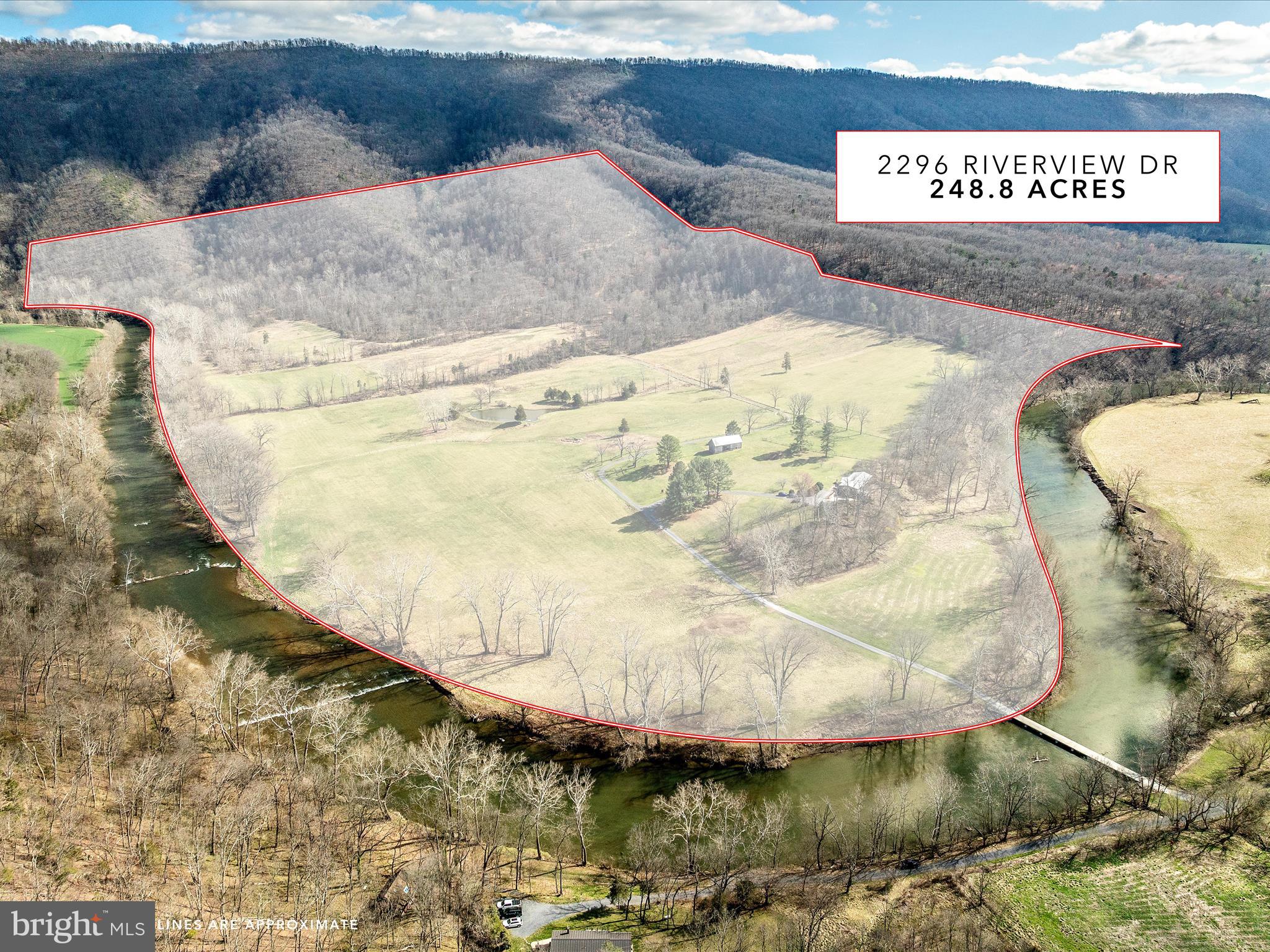 Welcome to one of the most unique properties in the Shenandoah Valley. This stunning riverfront retreat in the heart of Shenandoah County feels like a private island, accessible via your own bridge, ensuring unmatched peace and seclusion.
Outdoor enthusiasts will find endless opportunities for adventure, with activities such as hiking, biking, hunting, fishing, kayaking, and canoeing right at your doorstep. Spanning more than 248 acres, this property is nestled in the George Washington National Forest, and boasts 1.3 miles of riverfront along the North Fork of the Shenandoah River.
With 50 acres of open land currently used for haying, and 200 wooded acres featuring miles of hiking, ATV, and horse trails, you have direct access to thousands of acres of national forest hiking trails. The property hosts a wide array of wildlife, including bald eagles, ducks, deer, turkeys, foxes, river otters and many other native animals.
The charming two-story home, once owned by renowned sculptor Felix de Weldon (creator of the Iwo Jima statue at Arlington National Cemetery), features four bedrooms with private baths, a spacious open living area with a striking two-sided wood fireplace, a fully-equiped kitchen, a breakfast nook, and a dining room. Floor-to-ceiling glass and Pella doors seamlessly blend indoor and outdoor living, allowing you to soak in breathtaking 360-degree views that make the surrounding landscape feel like an extension of your home.
Step out to the large front deck, where you can enjoy panoramic views of the river and the pastoral beauty of Shenandoah Valley against the backdrop of the western mountains. From the rear patio, watch the sun come up over the majestic Massanutten Mountain Range, showcasing a picturesque pre-Civil War log barn, lush pastures, a half acre pond stocked with bass and catfish, and the vast George Washington National Forest on the horizon.
The lower level of this exquisite home includes two bedrooms with baths, a cozy living area with a wood stove, a small wine cellar, a utility room, and a two-car garage. A concrete patio connects directly to paths down to the river and up to the mountains, offering the same stunning vistas of the river, valley, and mountains.
Located on a gated private road, viewing this exceptional retreat requires 24-hour notice.
Access is by appointment only and accompanied by the listing agent.