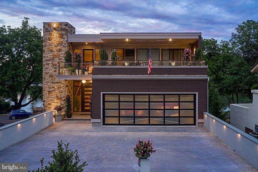 Modern Riverfront Estate with Unparalleled Indoor-Outdoor Living

Welcome to 182 S. Main Street, a rare opportunity to own one of New Hope’s few new-construction riverfront estates. Built in 2021 with every luxury in mind, this architectural showpiece blends cutting-edge design with the timeless allure of life along the Delaware River.

From the moment you enter the two-story foyer, you’re met with sweeping river views that flow throughout the home’s open living spaces. The main level features radiant-heated floors, a chef’s kitchen with  Sub-Zero refrigerators, wine refrigerator, and Wolfe gas stove and double ovens with warming drawer, plus a wet bar with sink, refrigerator, and ice maker—ideal for entertaining in every season. The adjoining family room opens to a spacious riverfront terrace, creating an effortless connection between indoor and outdoor living that is truly unparalleled. Additionally there is a half bath and laundry on the main level. 

The primary suite on the main level serves as a private retreat, complete with two large walk-in closets—one showcasing a sparkling chandelier and built-in TV for a touch of glamour—along with a spa-inspired bath.

Upstairs, you’ll find three additional bedroom suites, each with a private bath, as well as a dedicated office and an expansive family/media room with bar and an additional half bath and laundry. The upstairs bathrooms feature radiant-heated porcelain floors, and the family room boasts a 100-inch drop-down screen, wet bar with ice maker, microwave, refrigerator, and dishwasher, and panoramic river views. This versatile upper level can function as a private living area for family or  guests, with both front and rear terraces extending the space outdoors. 

The home’s roof deck offers one of New Hope’s most exceptional outdoor living experiences—a dramatic vantage point complete with a fireplace and unrivaled views of the river and fireworks, making it one of the area’s most spectacular private spaces.

The lower level continues the sense of luxury with 10-foot ceilings and radiant-heated floors throughout. The media and game room opens to a covered patio with built-in heaters and a private hot tub overlooking the water. From here, a floating dock provides direct access for boats and two jet skis, making river recreation effortless.

Car enthusiasts will appreciate the innovative car-lift system connecting the main-level garage to the lower level, accommodating four vehicles below, one on the lift, and two in the main garage—plus parking for five additional cars in the driveway. A large storage space beneath the driveway provides ample room for summer gear, river toys, and seasonal décor. There is also an additional storage space that has a garage door to the backyard, great for bringing water toys in or versatile storage space. 

Additional features include:
• Fully integrated smart-home system controlling lights, shades, and sound throughout
• Hardwired indoor and outdoor speaker system
• Professionally landscaped riverfront grounds

With its unmatched combination of design, technology, and river access, 182 S. Main Street stands as one of New Hope’s most remarkable modern estates—offering unparalleled indoor-outdoor living just steps from the heart of downtown.