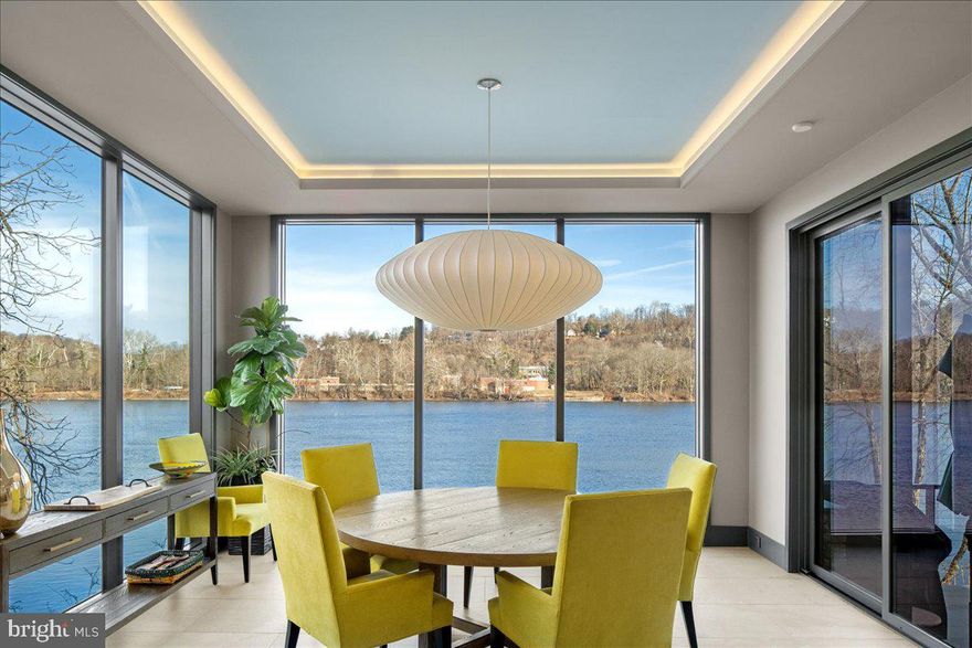 Modern Riverfront Estate with Unparalleled Indoor-Outdoor Living

Welcome to 182 S. Main Street, a rare opportunity to own one of New Hope’s few new-construction riverfront estates. Built in 2021 with every luxury in mind, this architectural showpiece blends cutting-edge design with the timeless allure of life along the Delaware River.

From the moment you enter the two-story foyer, you’re met with sweeping river views that flow throughout the home’s open living spaces. The main level features radiant-heated floors, a chef’s kitchen with  Sub-Zero refrigerators, wine refrigerator, and Wolfe gas stove and double ovens with warming drawer, plus a wet bar with sink, refrigerator, and ice maker—ideal for entertaining in every season. The adjoining family room opens to a spacious riverfront terrace, creating an effortless connection between indoor and outdoor living that is truly unparalleled. Additionally there is a half bath and laundry on the main level. 

The primary suite on the main level serves as a private retreat, complete with two large walk-in closets—one showcasing a sparkling chandelier and built-in TV for a touch of glamour—along with a spa-inspired bath.

Upstairs, you’ll find three additional bedroom suites, each with a private bath, as well as a dedicated office and an expansive family/media room with bar and an additional half bath and laundry. The upstairs bathrooms feature radiant-heated porcelain floors, and the family room boasts a 100-inch drop-down screen, wet bar with ice maker, microwave, refrigerator, and dishwasher, and panoramic river views. This versatile upper level can function as a private living area for family or  guests, with both front and rear terraces extending the space outdoors. 

The home’s roof deck offers one of New Hope’s most exceptional outdoor living experiences—a dramatic vantage point complete with a fireplace and unrivaled views of the river and fireworks, making it one of the area’s most spectacular private spaces.

The lower level continues the sense of luxury with 10-foot ceilings and radiant-heated floors throughout. The media and game room opens to a covered patio with built-in heaters and a private hot tub overlooking the water. From here, a floating dock provides direct access for boats and two jet skis, making river recreation effortless.

Car enthusiasts will appreciate the innovative car-lift system connecting the main-level garage to the lower level, accommodating four vehicles below, one on the lift, and two in the main garage—plus parking for five additional cars in the driveway. A large storage space beneath the driveway provides ample room for summer gear, river toys, and seasonal décor. There is also an additional storage space that has a garage door to the backyard, great for bringing water toys in or versatile storage space. 

Additional features include:
• Fully integrated smart-home system controlling lights, shades, and sound throughout
• Hardwired indoor and outdoor speaker system
• Professionally landscaped riverfront grounds

With its unmatched combination of design, technology, and river access, 182 S. Main Street stands as one of New Hope’s most remarkable modern estates—offering unparalleled indoor-outdoor living just steps from the heart of downtown.