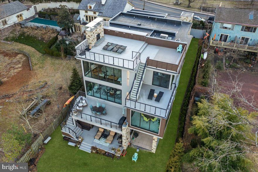 Modern Riverfront Estate with Unparalleled Indoor-Outdoor Living

Welcome to 182 S. Main Street, a rare opportunity to own one of New Hope’s few new-construction riverfront estates. Built in 2021 with every luxury in mind, this architectural showpiece blends cutting-edge design with the timeless allure of life along the Delaware River.

From the moment you enter the two-story foyer, you’re met with sweeping river views that flow throughout the home’s open living spaces. The main level features radiant-heated floors, a chef’s kitchen with  Sub-Zero refrigerators, wine refrigerator, and Wolfe gas stove and double ovens with warming drawer, plus a wet bar with sink, refrigerator, and ice maker—ideal for entertaining in every season. The adjoining family room opens to a spacious riverfront terrace, creating an effortless connection between indoor and outdoor living that is truly unparalleled. Additionally there is a half bath and laundry on the main level. 

The primary suite on the main level serves as a private retreat, complete with two large walk-in closets—one showcasing a sparkling chandelier and built-in TV for a touch of glamour—along with a spa-inspired bath.

Upstairs, you’ll find three additional bedroom suites, each with a private bath, as well as a dedicated office and an expansive family/media room with bar and an additional half bath and laundry. The upstairs bathrooms feature radiant-heated porcelain floors, and the family room boasts a 100-inch drop-down screen, wet bar with ice maker, microwave, refrigerator, and dishwasher, and panoramic river views. This versatile upper level can function as a private living area for family or  guests, with both front and rear terraces extending the space outdoors. 

The home’s roof deck offers one of New Hope’s most exceptional outdoor living experiences—a dramatic vantage point complete with a fireplace and unrivaled views of the river and fireworks, making it one of the area’s most spectacular private spaces.

The lower level continues the sense of luxury with 10-foot ceilings and radiant-heated floors throughout. The media and game room opens to a covered patio with built-in heaters and a private hot tub overlooking the water. From here, a floating dock provides direct access for boats and two jet skis, making river recreation effortless.

Car enthusiasts will appreciate the innovative car-lift system connecting the main-level garage to the lower level, accommodating four vehicles below, one on the lift, and two in the main garage—plus parking for five additional cars in the driveway. A large storage space beneath the driveway provides ample room for summer gear, river toys, and seasonal décor. There is also an additional storage space that has a garage door to the backyard, great for bringing water toys in or versatile storage space. 

Additional features include:
• Fully integrated smart-home system controlling lights, shades, and sound throughout
• Hardwired indoor and outdoor speaker system
• Professionally landscaped riverfront grounds

With its unmatched combination of design, technology, and river access, 182 S. Main Street stands as one of New Hope’s most remarkable modern estates—offering unparalleled indoor-outdoor living just steps from the heart of downtown.