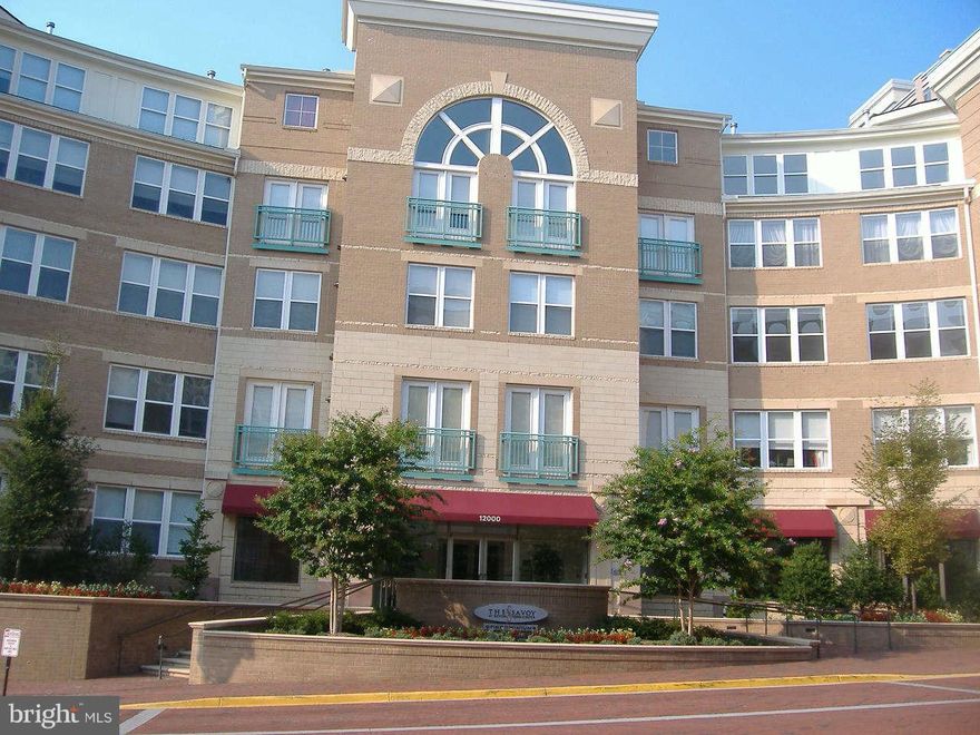 Spacious one-bedroom unit at The Savoy in Reston Town Center, offering 754 sq ft of living space. This unit features a balcony, in-unit washer/dryer, ample closet space, modern design with tall ceilings, and a built-in computer desk. New flooring was installed in December 2023. Includes garage space #131GL. Residents enjoy upscale amenities, including a reception area, billiards, media room, exercise facilities, all professionally managed. Schedule your showings online.