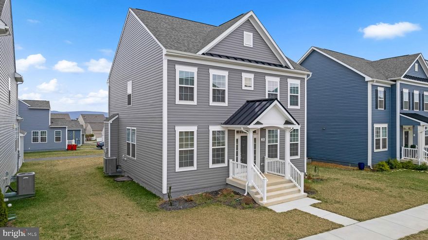 This beautiful, like-new Colonial in the desirable Huntfield community offers the perfect blend of comfort and elegance. Less than two years old, this home is still in like-new condition and completely move-in ready, featuring rich vinyl floors throughout, plush carpeting in the bedrooms, and a spacious gourmet kitchen with a large island, wall oven, and cooktop—ideal for any chef. The cozy family room includes a gas fireplace, perfect for relaxation. The luxurious primary suite boasts a tray ceiling, a giant walk-in closet, and a spa-like bathroom with a soaking tub and walk-in shower. With 4 bedrooms and 2.5 bathrooms, there’s plenty of space for everyone. The partially finished basement offers endless possibilities, including rough-in plumbing for a future bathroom and 5th bedroom. Outside, the well-maintained exterior and lawn complement the vibrant community amenities, including sidewalks, playground, and tennis/pickleball courts. Future amenities include swimming pool, basketball courts and community center. The HOA handles maintenance, snow removal, and trash services, allowing for a low-maintenance lifestyle. Parking is easy with a paved driveway in back or on-street parking in front.  Only a couple miles from VA and MD, it's the perfect location. This exceptional home is a must-see! Schedule a showing today!