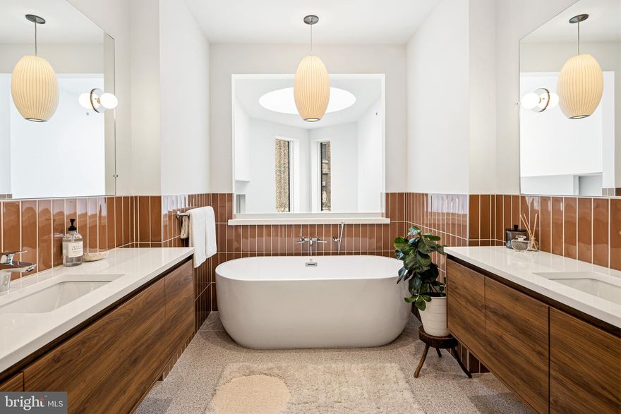 Rodger’s Row presents a thoughtfully designed residence where timeless mid-century influence is reinterpreted through a refined, modern lens. This is a home defined by intention—where clean lines, natural light, and functional elegance converge.

At the rear, two off-street parking spaces provide rare convenience, complemented by a private garden that serves as a quiet extension of the living space. Oversized sliding glass doors create a seamless indoor-outdoor connection, enhancing both light and livability. Inside, the main level unfolds with a sense of openness and calm. A dramatic four-story atrium draws natural light deep into the home, creating a soft, ever-changing ambiance throughout the day.

The living and dining areas are inviting yet understated, designed for effortless gathering and everyday comfort. Just beyond, the kitchen balances form and function with a curated blend of warm finishes and modern detailing.

The second floor offers a flexible, open-concept level that adapts to a variety of needs—whether a home office, library, or secondary living area. Generous front-facing windows, transom details, and thoughtful architectural elements create a sense of continuity and lightness. This level also features two bedrooms and two bathrooms connected by a well-considered Jack-and-Jill balcony.

The third-floor primary suite serves as a private retreat. Spacious and serene, it is complemented by a discreet coffee bar, space for integrated wine storage or a writing nook, and direct access to a private balcony. Pocket doors provide separation when desired, allowing the space to transition seamlessly between openness and privacy.

Above, a full roof deck offers sweeping 360-degree views and an elevated setting for quiet evenings or intimate entertaining.

The lower level introduces a calm, versatile retreat with a generous rec room, a fully equipped guest bedroom and bathroom, and ample storage. Laundry is conveniently located on the second floor.

Positioned in the heart of Fishtown, just moments from Adaire School and the neighborhood’s most notable amenities, Rodger’s Row offers a rare opportunity to own a home that balances architectural character with modern sophistication. A residence designed to endure—both in style and in function.  

3% seller assist offered for buyer to customize the window above the primary bathtub and the handrail.