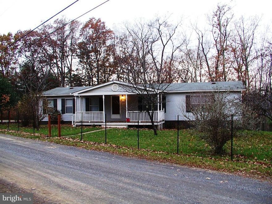 This home is situated on 2 1/2 peaceful acres of serene, flat land with mountain views. It has three large bedrooms with cathedral ceilings & two full bathrooms. The master bath has a garden soaking tub. The home is completely remodeled with fresh paint and new carpets. Enjoy the large front porch and the extra large deck. Call for the low price. wonderful mountain views! All sizes approx