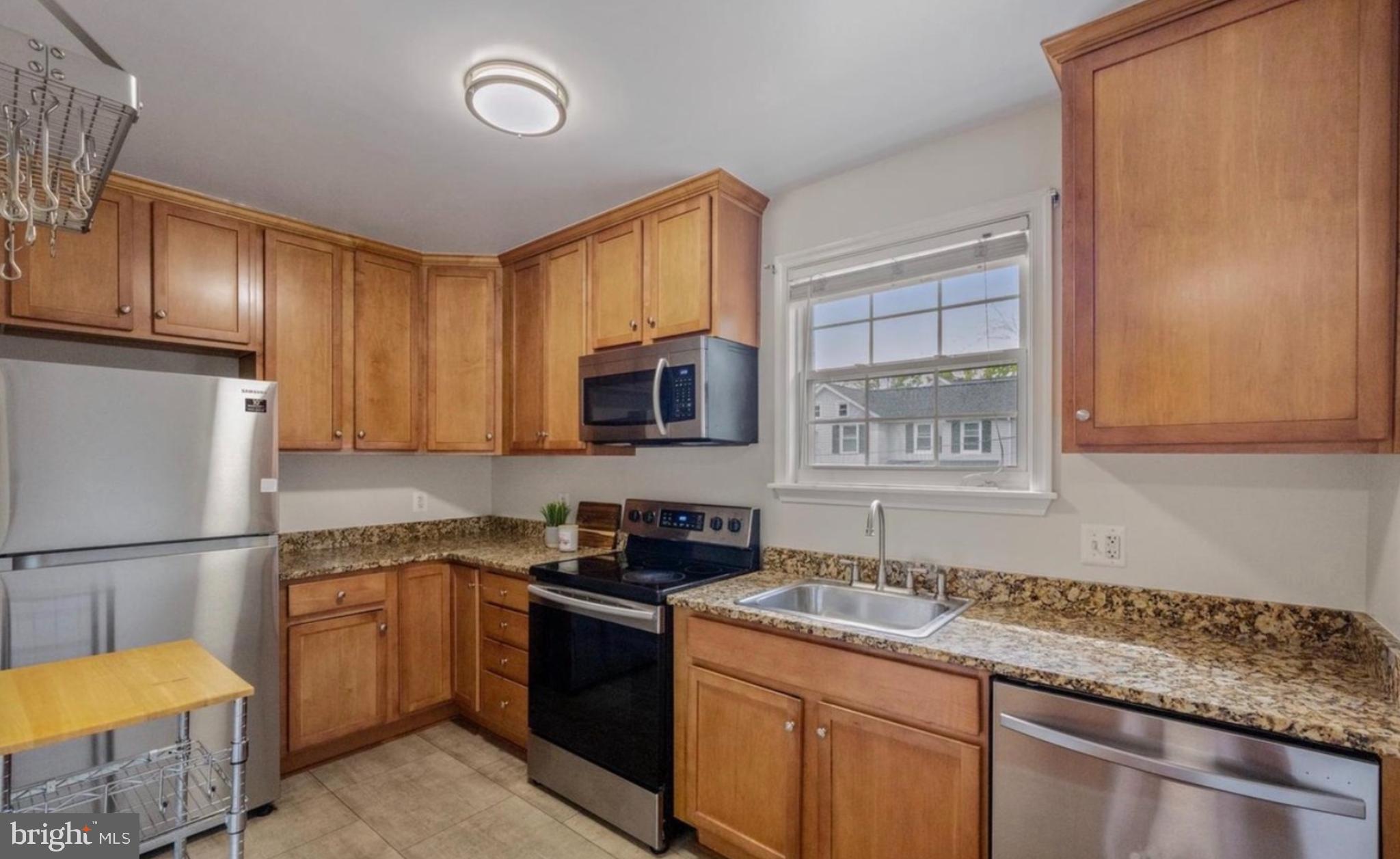 Spacious 1 + 1 Condo -- Small town living right off Laurel’s Historic Main Street. This fully upgraded condo is nestled on a tree lined lot steps away from Riverfront Park with walking trails running adjacent to the scenic Patuxent River. This charmer welcomes you home with a spacious living room that is the centerpiece of the open floor plan. The nicely updated kitchen features stainless steel appliances and granite countertops. Additional storage unit located within this well maintained brick building allows you to keep your living space simple and neat while having access to all your extra household needs. Large bedroom and full bath make this condo one not to miss. Minutes to MARC station and all major commuter routes.
