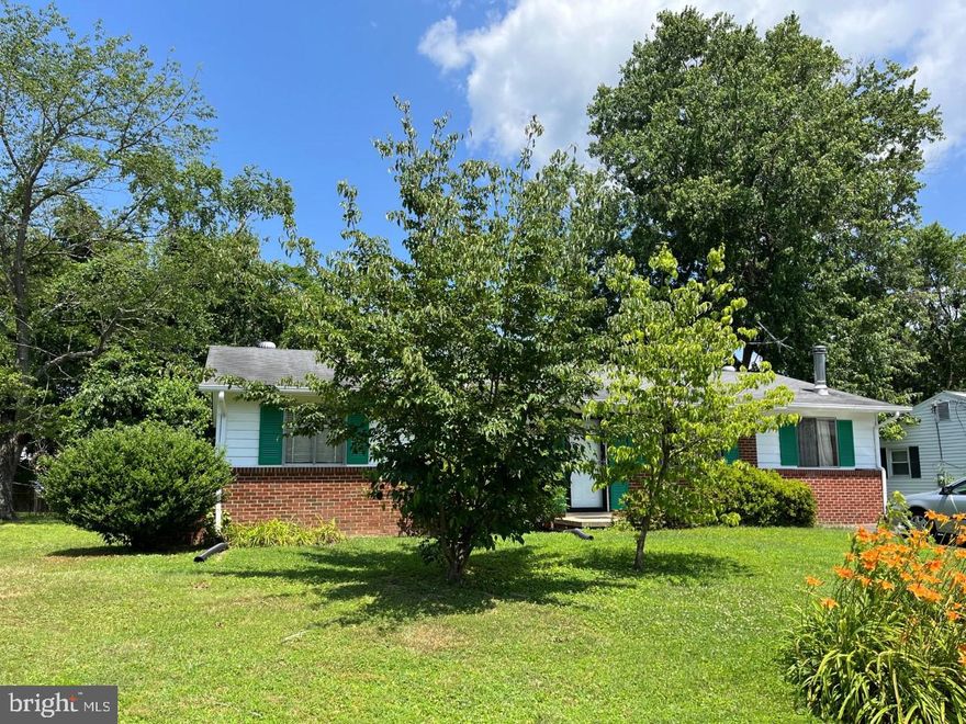 1 level detached rambler on nice 1/4 acre, treed lot in Dumfries! 3 Bedrooms and 1 Full Bath.  Open living room, dining room, and kitchen. The exterior was painted in 2020. Home has vinyl siding and central AC.  The  hot water heater was replaced in  2017. Attic has pull down stairs. The yard is landscaped with dogwoods, daylilies & hydrangeas.