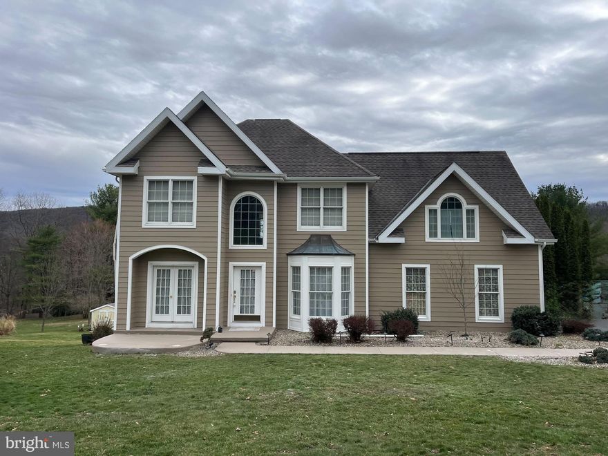 Experience space, privacy, and breathtaking mountain views—all just moments from town. This beautiful contemporary home features a welcoming two-story foyer and a layout that perfectly balances refined entertaining with everyday comfort. Offering 4 bedrooms and 3½ baths in the sought-after Blue Mountain School District, the home includes two fireplaces and a finished lower level ideal for guests, extended family, or flexible living space. Plenty of storage, utility areas, and a heated craft room or workshop add to the home’s versatility. Outdoor living shines with a large trex deck and concrete patio where you can relax and take in the stunning scenery. The primary suite serves as a peaceful retreat with a sitting area, walk-in closet, and a spa-like private bath designed for ultimate relaxation. An exceptional property you won’t want to miss.