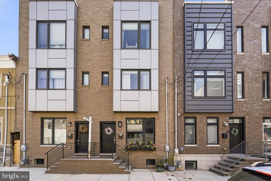 Welcome to 1337 S Opal Street, a stunning contemporary townhouse nestled in the heart of Philadelphia’s vibrant Point Breeze neighborhood. Built in 2018, this 2,100-square-foot residence masterfully blends modern luxury with urban convenience, and has 3+ years left on the tax abatement. The home greets you with an expansive open-concept main floor, featuring rich hardwood flooring, high ceilings, and recessed lighting that flows seamlessly from the inviting living area into a gourmet eat-in kitchen. Equipped with sleek cabinetry, high-end stainless steel appliances, and quartz countertops with island seating, the kitchen is a chef’s dream—perfect for hosting intimate dinners or larger gatherings. Just beyond the kitchen, a private fenced rear patio offers a tranquil outdoor retreat for morning coffee or alfresco dining.

The upper levels are thoughtfully designed for privacy and comfort. The second floor hosts two spacious, light-filled bedrooms with generous closet space and a stylishly appointed full bathroom featuring designer tile work. The entire third floor is dedicated to a luxurious primary suite, a true urban sanctuary boasting a massive walk-through closet and a spa-like ensuite bathroom with dual vanities and premium finishes. Crowning the home is a spectacular private roof deck that provides breathtaking, unobstructed views of the Center City skyline—the ultimate backdrop for evening entertaining or watching the sunset.

Beyond the main living floors, the finished lower level adds versatile space for a media room, home gym, or office, and includes a convenient laundry area and additional storage. Situated on a quiet, charming street, this home places you just steps away from local favorites like the American Sardine Bar and Dock Street Brewery, with the shops and dining of Rittenhouse Square and Center City just a short commute away. With its sleek design and prime location, this property offers an exceptional opportunity to experience the best of Philadelphia living.