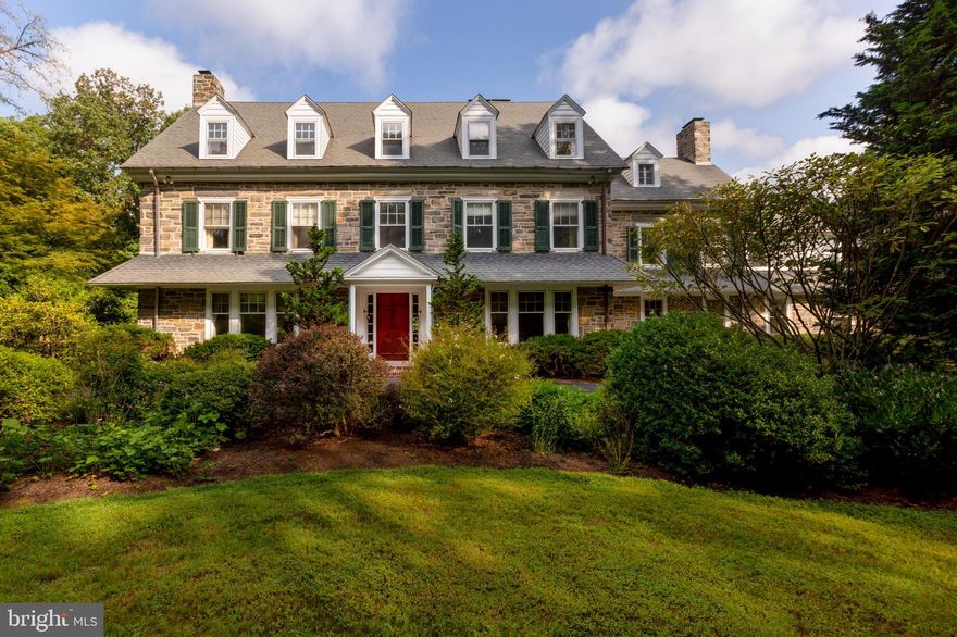 Solidly built from the finest materials, this gracious Haverford home welcomes the family that values fine craftsmanship. Original owner, Hugh McIlvain, a hardwood lumber merchant and philanthropist, oversaw all details when this house was built in 1921, from selecting the mahogany used for the grand front staircase, to choosing the glittering Wissahickon schist that constitutes the thick walls. Two acres of lovingly tended landscape - complete with a small pond, garden plots, and seating areas - create an outdoor haven to surround this seven-bedroom home and carriage house. Mahogany doors and a true through-center hall greet the visitor, whose eye travels up to a Palladian window on the landing. French doors lead into the large living room with its oak floors, deep sills, sub-floor firewood storage, and fireplace with mahogany mantel. Across the hall is a dining room with built-in corner cabinets, wainscoting, and a brick fireplace surrounded by dental molding. Also off the entry hall is a library with built-in bookcases, a fireplace with original millwork, and a wide window seat. A butlers pantry with handsome kitchen dressers connects the dining room to the functional kitchen, with its brick chimney and generous pass-through to a bright breakfast room and exposed schist arch. Two powder rooms and plentiful closets with solid, snug-fitting doors and original hardware complete the first floor. The second-floor master bedroom has a peaceful windowed seating area, four large closets, a fireplace with decorative mantel, and an attached bath. Also accessed from the second-floor hall: a princess suite with bath, a third well-scaled bedroom, and a hall bath with original hexagonal floor tile. Set apart, next to an enclosed back staircase, is a charming small study or bedroom with a marble fireplace. Attached is a sleeping porch with beadboard and attractive, horizontally-hinged windows on three exposures. The third floor features three spacious bedrooms with substantial baseboards, garret ceilings, and treetop views as well as a large hall bath. Two additional bonus rooms - one with double cedar closets - could be used as den, billiards, or office spaces. Outdoor features of the home include a covered open-air porch with original O.W. Ketcham Old Dutch terra cotta tiles and a wooden deck. The original window sills are Indiana limestone and the gutters and downspouts are aluminum. The nearby carriage house offers space for five cars and garden equipment. Above the garage are three+ bedrooms, two baths, and a rustic kitchen. A recent inspector called 526 College Avenue the most solidly built house he had seen in his long career. Perfectly proportioned, this home and property offer both beauty and superior quality to the discerning buyer.
