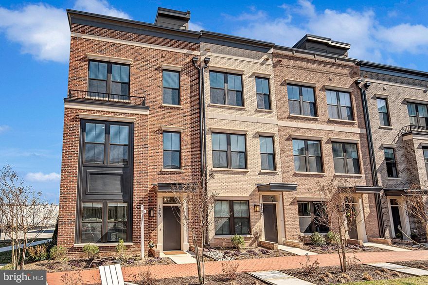 Discover the epitome of luxury living in this stunning, brand-new construction end-unit townhome with ELEVATOR located at 1249 Northside Park Boulevard. As a premier and rare end-unit, this home is bathed in natural light from three sides, beautifully highlighting its contemporary brownstone architecture and extensive premium upgrades. The expansive interior spans four finished levels, featuring an open-concept main floor with soaring nine-foot ceilings, wide-plank flooring, and a sleek linear gas fireplace. The chef’s kitchen is a true masterpiece, anchored by a dramatic waterfall-edge quartz island and equipped with top-of-the-line Bosch appliances, custom-paneled cabinetry, and a walk-in pantry. The first floor also has a two car garage with upgraded flooring and wall storage. 

The thoughtful design continues to the private quarters, where each of the four spacious bedrooms enjoys its own access to a full, upgraded bathroom. For ultimate convenience, a private in-home ELEVATOR serves every level, while a secondary zone electric heat pump and tankless water heater ensure modern energy efficiency. The crowning jewel of the residence is the fourth-level loft and its massive 269-square-foot rooftop terrace. This outdoor sanctuary provides an incredible space for sunset entertaining or quiet relaxation while overlooking the neighborhood skyline.

Life at Northside offers a seamless blend of recreation and convenience. Residents enjoy immediate proximity to the community’s lush three-acre central park, providing ample green space just steps from the front door. Health and wellness are equally accessible, with a Life Time Fitness Club located right in the neighborhood. Whether you are looking for a high-intensity workout or a relaxing day at the spa, the best-in-class fitness amenities can be part of your daily lifestyle.

The location is a commuter’s dream, perfectly positioned for both work and play. You are just steps away from the upscale dining and retail at Park Potomac and Potomac Woods Plaza, including local favorites like Harris Teeter and MoCo’s Founding Farmers. For travel throughout the DMV, the home offers immediate access to I-270, which is less than half a mile away. Commuters will also appreciate being just 1.5 miles from the Rockville Metro Station on the Red Line. Furthermore, you are only 2 miles from the vibrant entertainment hub of North Bethesda and a short 0.6-mile stroll from the peaceful trails of North Farm Park.